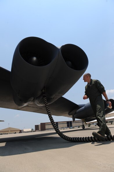 B-52 co-pilot 1st Lt. Dallas Wright, 20th Bomb Squadron, inspects the engine of a B-52H Stratofortress on Barksdale Air Force Base, La., June 28. Though the need for a 24-hour alert aircrew is not often necessary, aircrews still train and practice alert procedures and quick departures. (U.S. Air Force photo/Airman 1st Class Micaiah Anthony)(RELEASED)