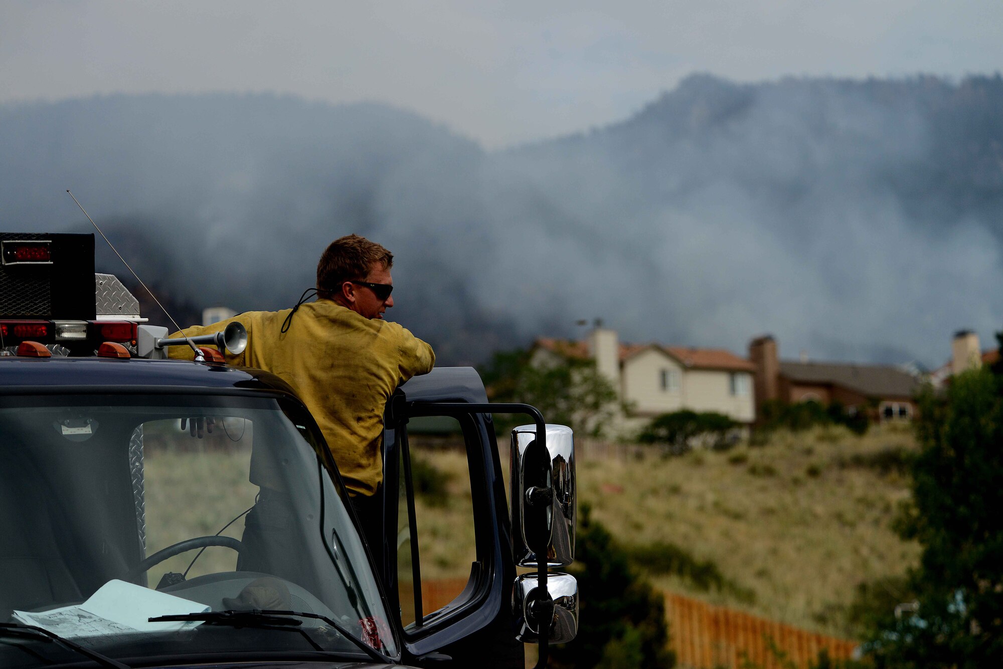 Richard Strange looks out at his worksite for the day in the Mount Saint Francois area of Colorado Springs, Colo., June 28, 2012. Strange and the rest of the firefighters o the Vandenberg Air Force Base, Calif., Hot Shots helped battle several fires in Waldo Canyon. (U.S. Air Force photo/Master Sgt. Jeremy Lock)