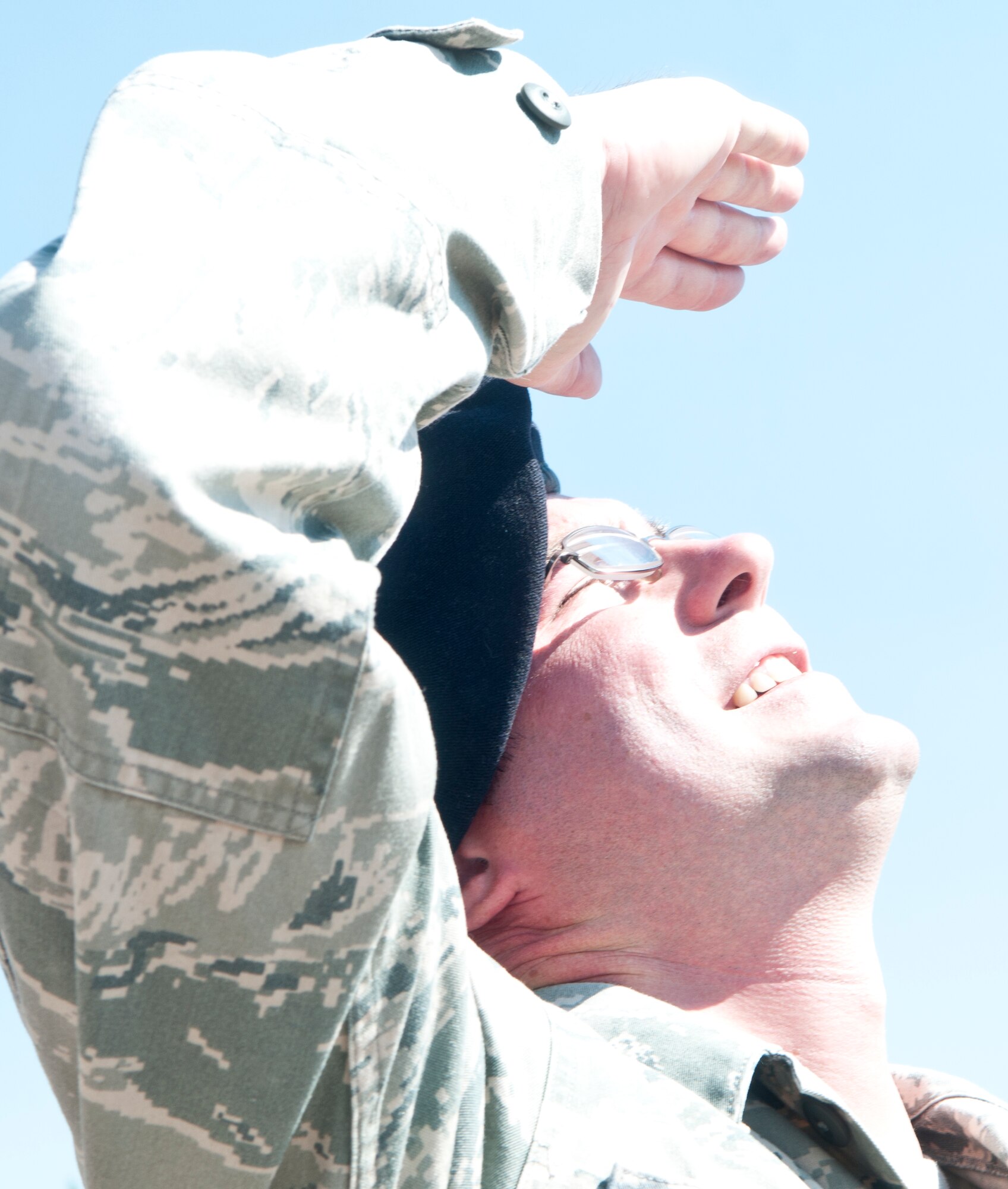Tech. Sgt. Scott Pennock, 90th Security Forces Group standards and evaluations assistant noncommissioned officer in charge, attempts to shield his eyes from sunlight outdoors on F. E. Warren Air Force Base, Wyo., June 26. (U.S. Air Force photo illustration by Airman 1st Class Jason Wiese)