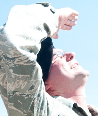 Tech. Sgt. Scott Pennock, 90th Security Forces Group standards and evaluations assistant noncommissioned officer in charge, attempts to shield his eyes from sunlight outdoors on F. E. Warren Air Force Base, Wyo., June 26. (U.S. Air Force photo illustration by Airman 1st Class Jason Wiese)