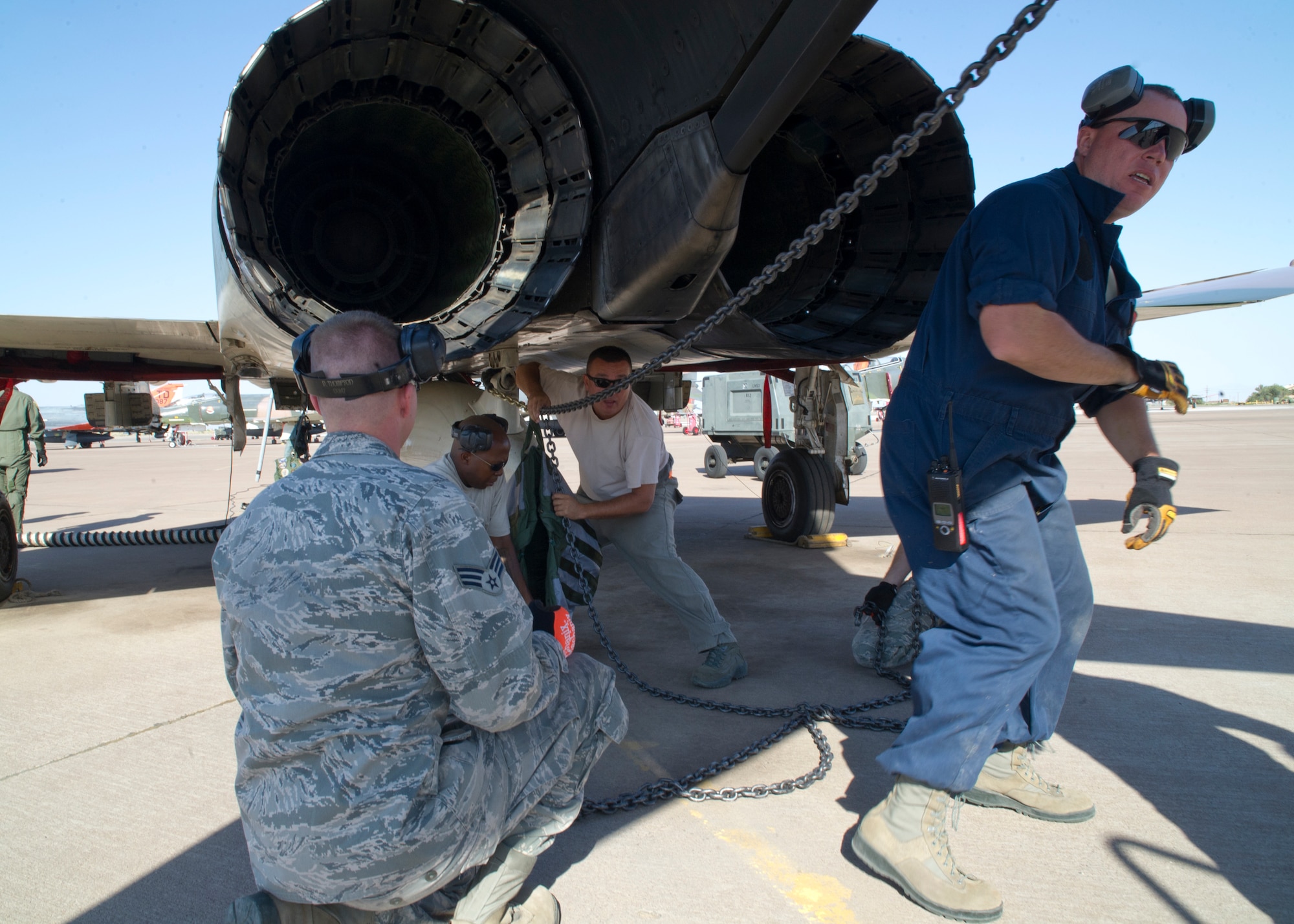 Members of the Detachment 1, 82nd Aerial Targets Squadron aircrew connect a chain from the “Combat Banner” to an F-4 Phantom during a Weapon Systems Evaluation Program at Holloman Air Force Base, N.M., June 19. During “Combat Banner” missions, a 40-foot banner is towed behind an F-4 Phantom, which is flown into the airspace to be shot at by the F-22 Raptor’s 20 mm cannon. The main purpose of the WSEP is to evaluate the total air-to-air weapon to verify the system’s performance, reliability, capabilities, limitations, recommend corrective actions, and maintain combat Air Force-wide data. (U.S. Air Force photo by Senior Airman Siuta B. Ika/Released)