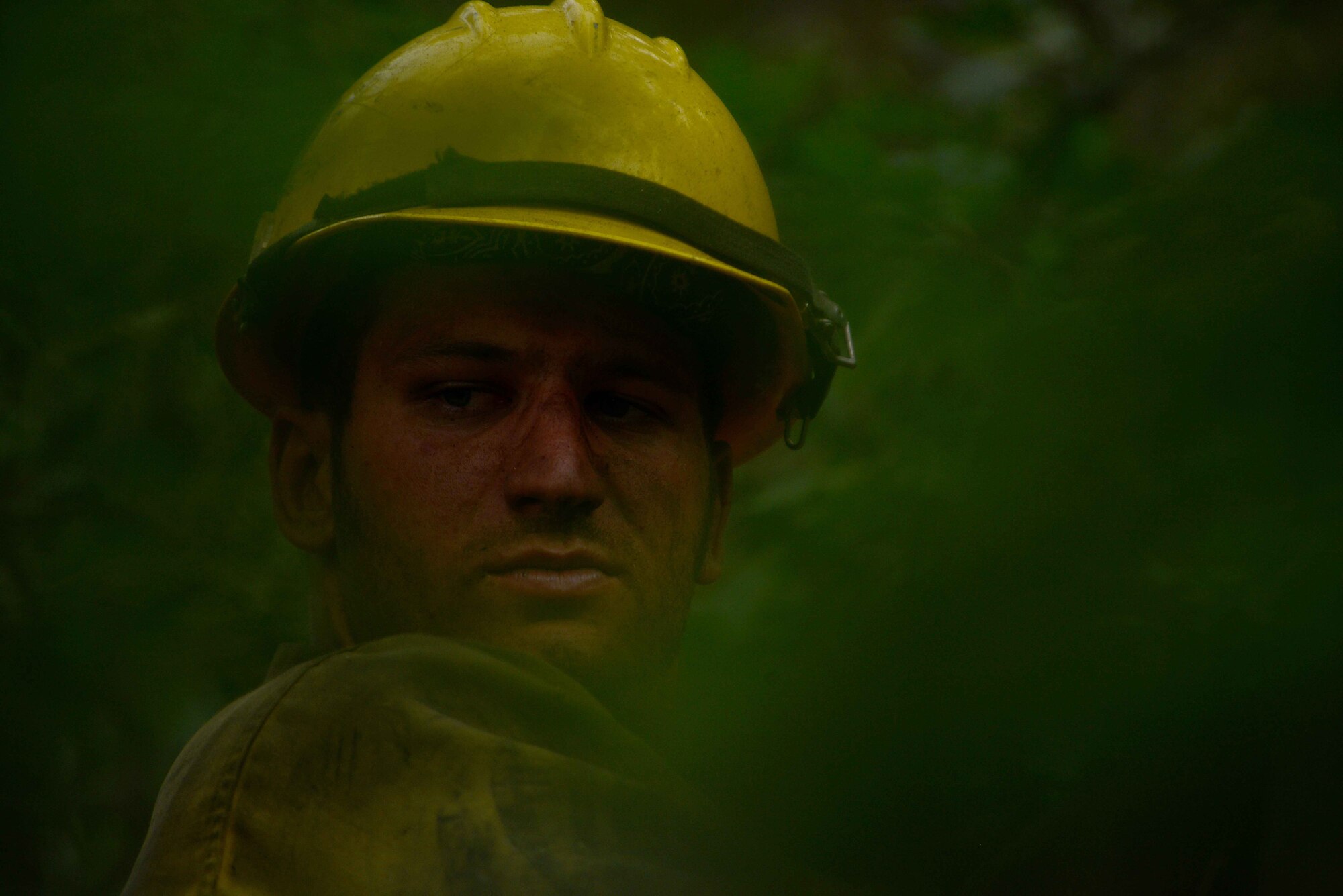 Brad Mabery cuts a tree with his chainsaw while clearing a fire line in the Mount Saint Francois area of Colorado Springs, Colo., on June 28, 2012. Mabery and the rest of the firefighters of the Vandenberg Air Force Base, Calif., Hot Shots are helping to battle several fires in Waldo Canyon. (U.S. Air Force photo/Master Sgt. Jeremy Lock)