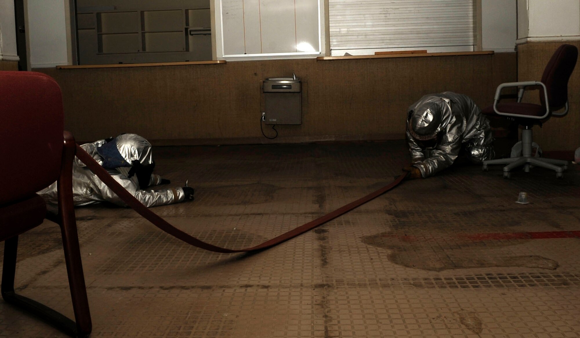 Firefighters from the 2nd Civil Engineer Squadron practice search and recovery skills on Barksdale Air Force Base, La. June 26. The firefighters had to locate each other and the exit in a vacant building with masks on and lights off. Firefighters train and exercise regularly to prepare for real world situations. (U.S. Air Force photo/Airman 1st Class Joseph A. Pagán Jr.)(RELEASED)