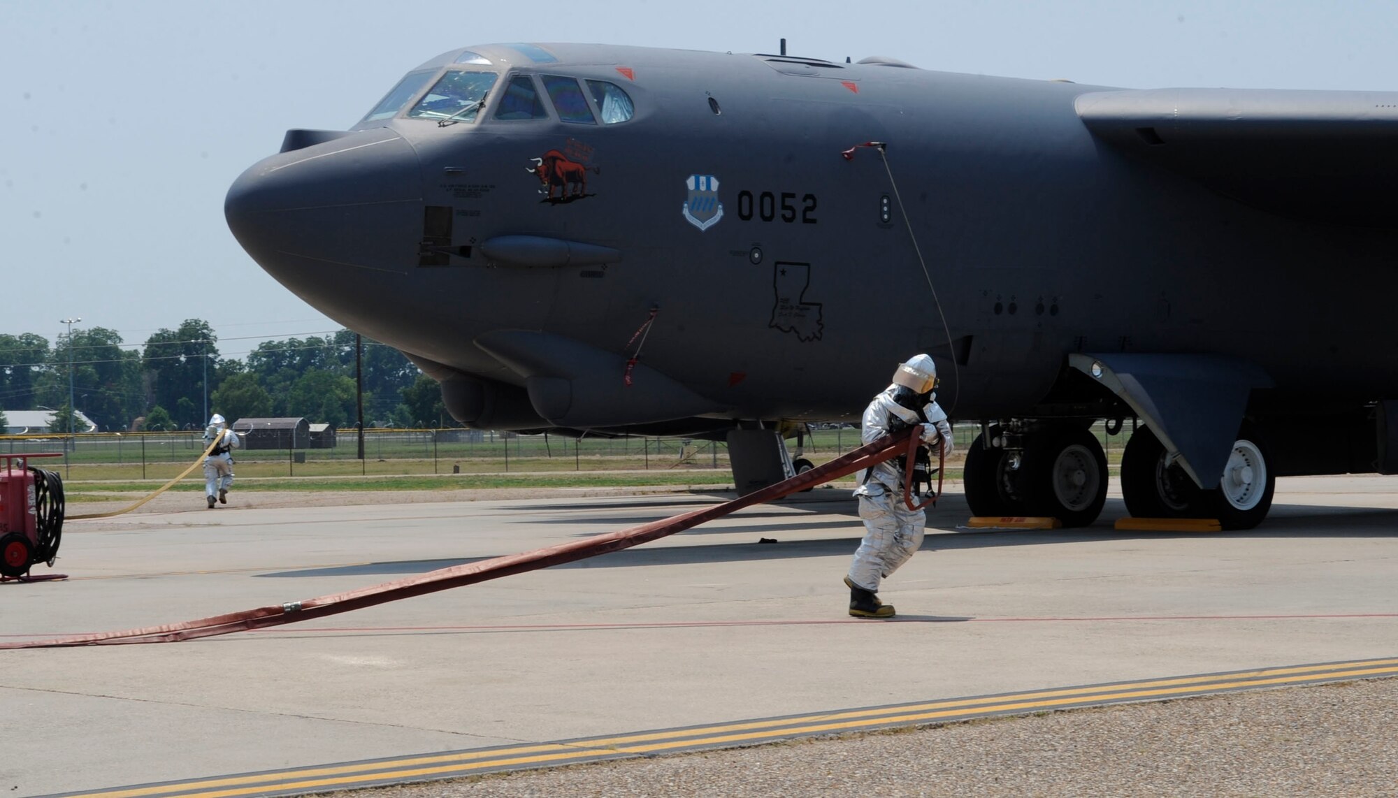 Firefighters from the 2nd Civil Engineer Squadron approach a simulated aircraft fire during a Nuclear Surety Exercise on Barksdale Air Force Base, La., June 26. Firefighters undergo specific training to ensure they can perform their duties in the presence of strategic assets. (U.S. Air Force photo/Airman 1st Class Joseph A. Pagán Jr.)(RELEASED)