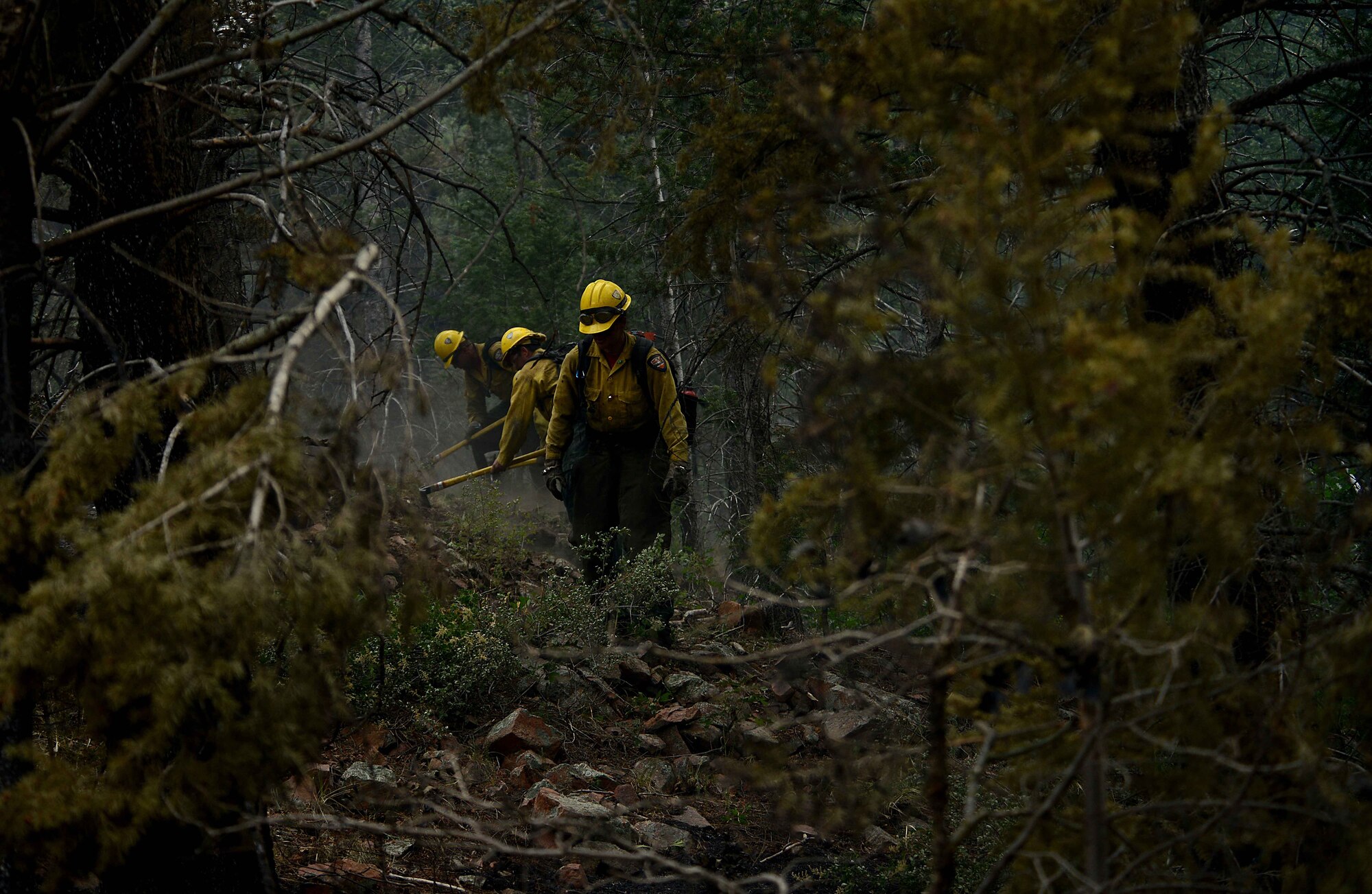 While helping to battle several fires in Waldo Canyon, firefighters with the Vandenberg Air Force Base, Calif., Hot Shots cut a fire line in the Mount Saint Francois area of Colorado Springs, Colo., June 28, 2012. The Waldo Canyon fire has grown to 18,500 acres and burned more than 300 homes. (U.S. Air Force photo/Master Sgt. Jeremy Lock)