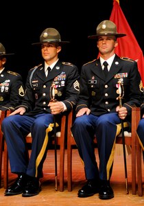 (From left) U.S. Army Staff Sgt. Jeffrey Heilman, a drill sergeant assigned to Fort Jackson, S.C., and Staff. Sgt. Jarod Moss, assigned to the 95th Reserve Division at Fort Sill, Okla., sit with their non-commissioned officer swords after being named active-duty and reserve Drill Sergeants of the Year respectively, at the closing ceremony for the U.S. Army’s 2012 DSOY competition at Fort Eustis, Va., June 29, 2012. The drill sergeants earned top honors from battalion level up through installation level, and represent the best drill sergeants in the Army. (U.S. Air Force photo by Senior Airman Wesley Farnsworth/Released)