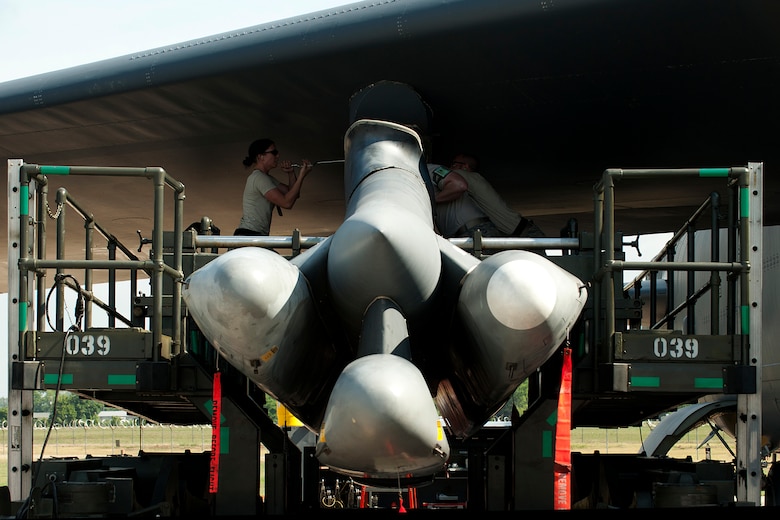 Weapons loaders assigned to the 707th Maintenance Squadron attach an Air Launched Cruise Missile Pylon underneath the wing of a B-52H Stratofortress, Barksdale Air Force Base, La., June 15, 2012. U.S. Air Force Master Sgt. James Hudson, Tech. Sgt. Donald Ballard, Staff Sgt. Matthew Bailey and Senior Airman Erin Bernik are members of the first load crew in the Air Force Reserve Command certified to load nuclear weapons on the B-52. (U.S. Air Force photo by Master Sgt. Greg Steele/Released)