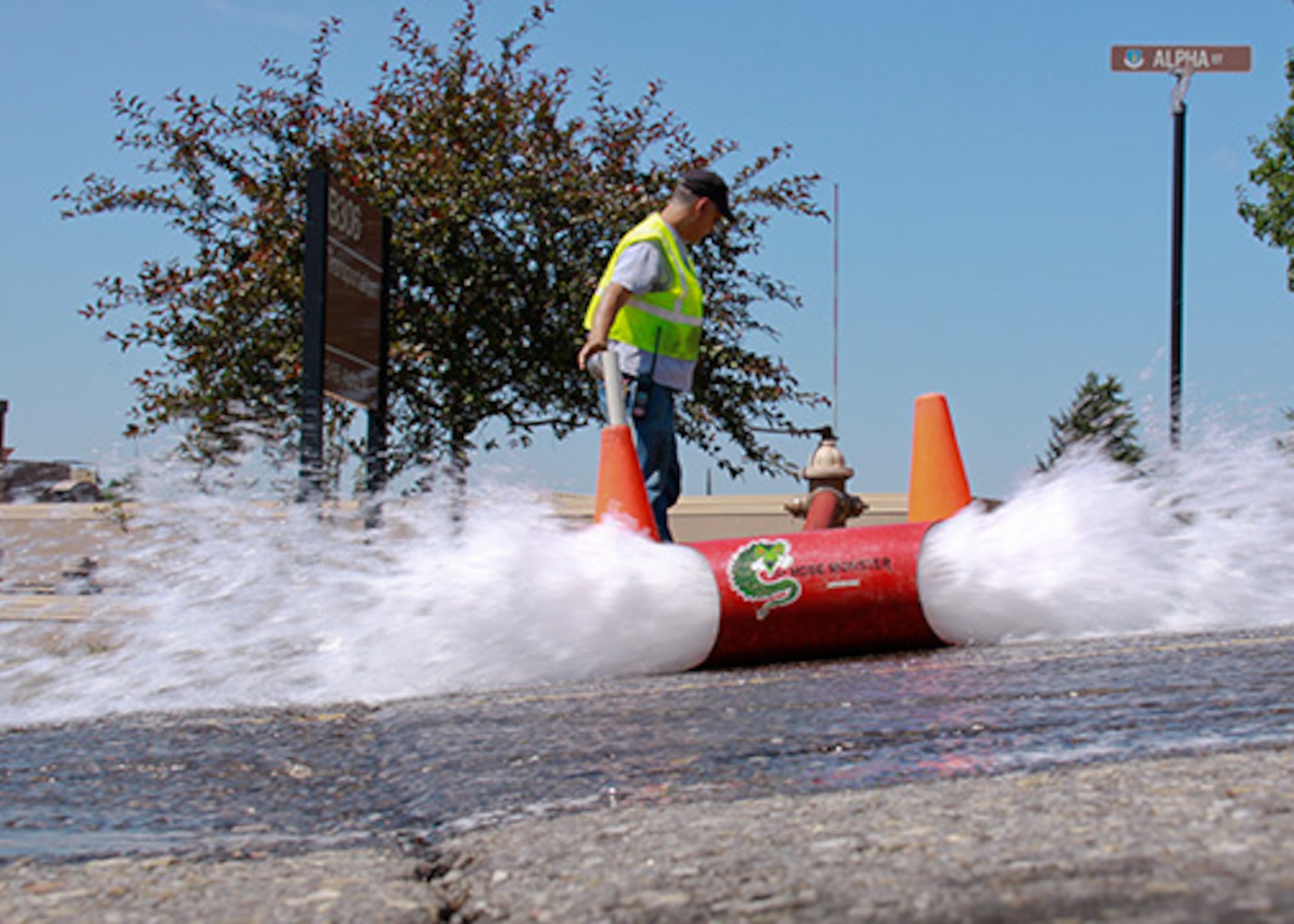 Ken Teets, a civilian contractor for Civil Engineering, runs a routine unidirectional water flush on the fire hydrant between the transportation and headquarters building at the 911th Airlift Wing, June 27, 2012. By utilizing this flush technique, Teets checks the water pressure of the fire hydrants and washes the sediment and dirt out of the pipes simultaneously. These routine inspections play a vital part in base safety in case of a fire or smoke emergency. (U.S. Air Force photo by Airman 1st Class Justyne Obeldobel/Released)