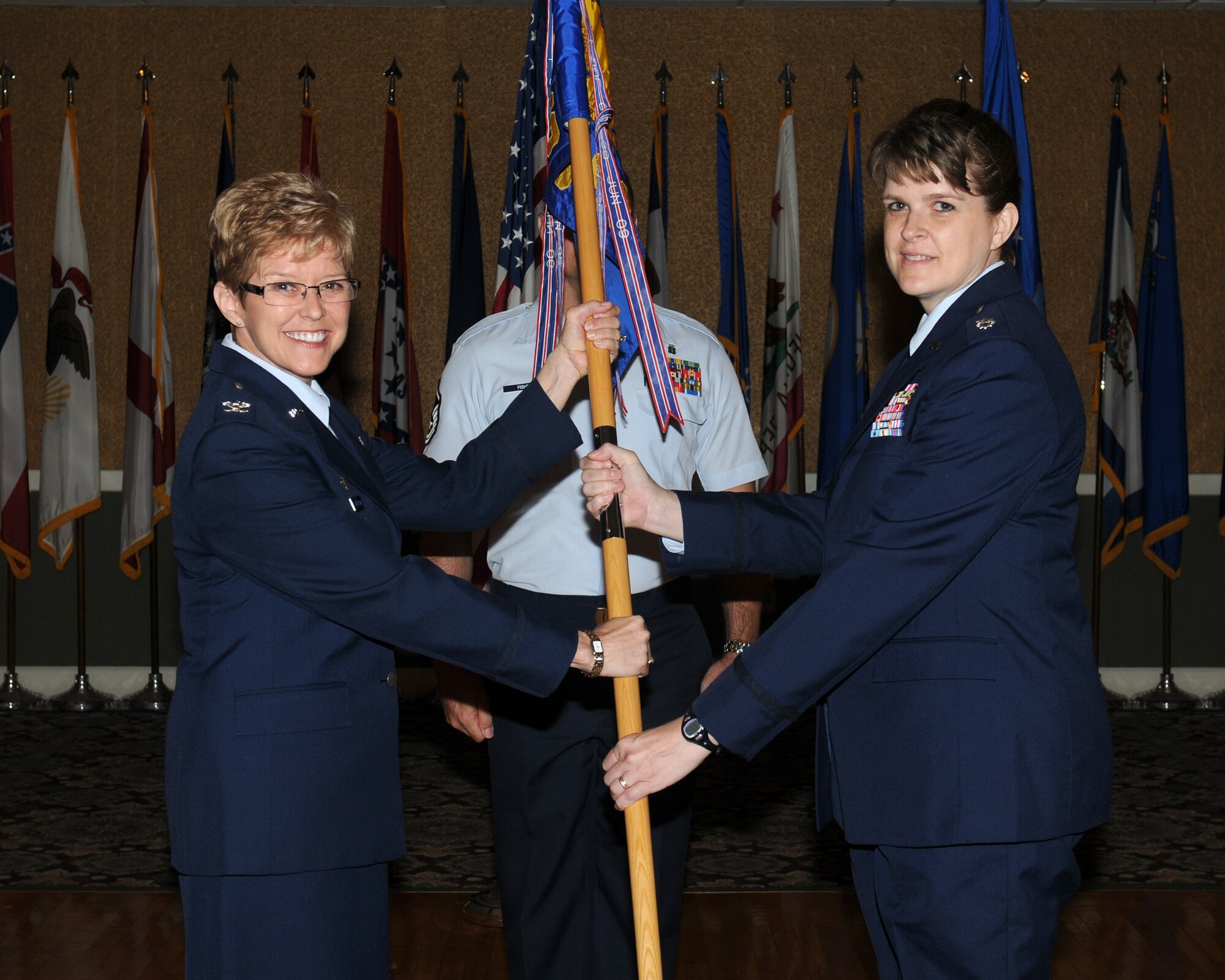 Col. Billye Hutchison, 14th Medical Group Commander passes the 14th Medical Support Squadron guidon to Lt. Col. Amy Woosley, 14th MDSS Commander during a change of command ceremony on June 21. (U.S. Air Force photo/Melissa Doublin)

