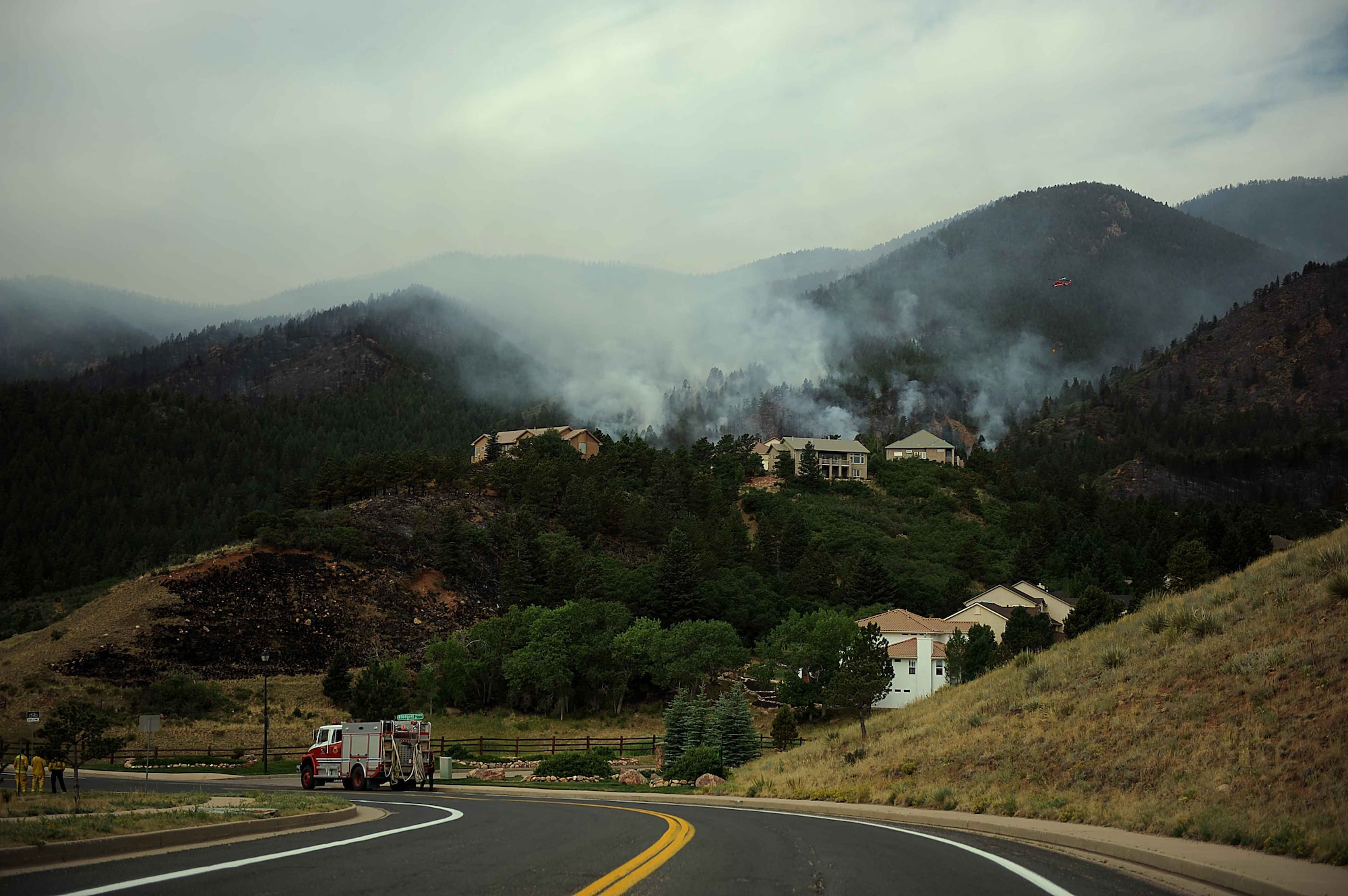 Fire still burns in the Mount Saint Francois area of Colorado Springs, Colo., while firefighters continue to battle several fires in Waldo Canyon on June 28, 2012. Currently, more than 90 firefighters from the Academy, along with assets from Air Force Space Command; F.E. Warren Air Force Base, Wyo.; Fort Carson, Colo.; and the local community continue to fight the Waldo Canyon fire.(U.S. Air Force photo/Master Sgt. Jeremy Lock)