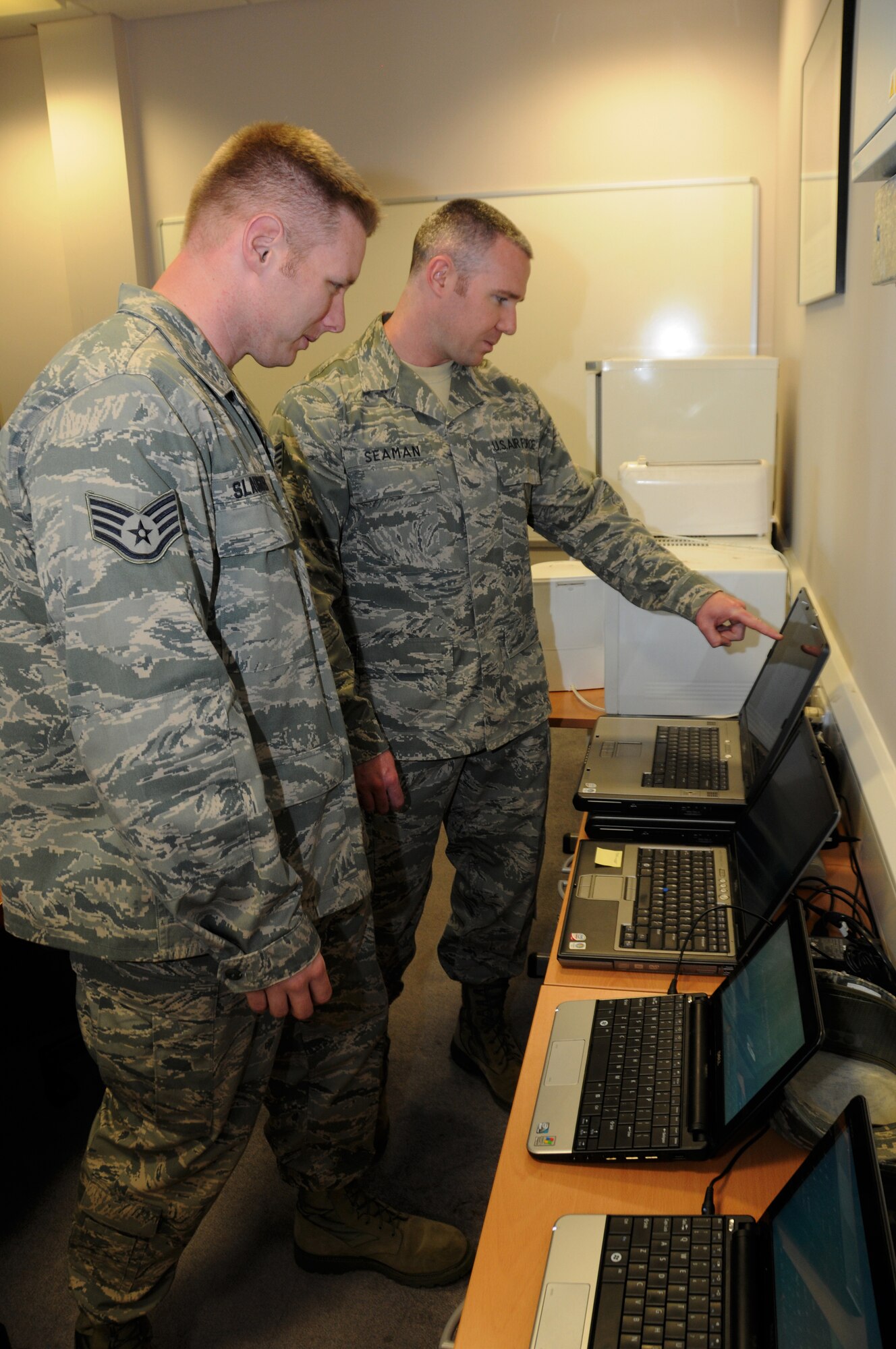 ROYAL AIR FORCE LAKENHEATH, England – Tech. Sgt. Garret Slaughter (left) and Staff Sgt. Ricky Seamen, 177th Communications Squadron cyber transport technicians, review information programs in 48th CS building June 26, 2012. Airmen from the 117th Air Refueling Wing visited the Liberty Wing for training and a chance to see how the 48th Fighter Wing operates.  (U.S. Air Force photo by Master Sgt. Ken Johnson)