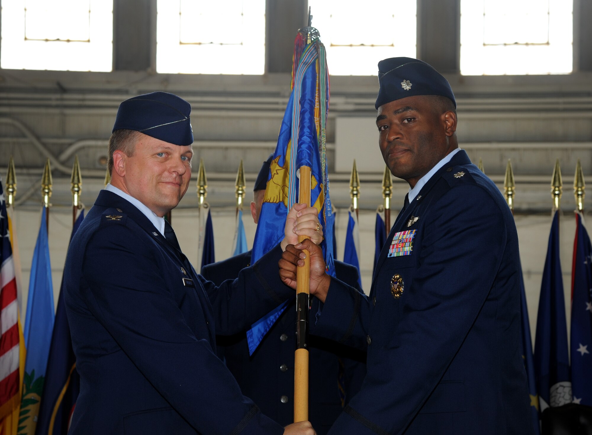 Col. Matthew Molineux, 6th Operations Group commander, passes the guidon to Lt. Col. Derrick Hodges, 310th Airlift Squadron commander, during the Change of Command ceremony at MacDill Air Force Base, Fla., June 22, 2012. (U.S. Air Force photo by Airman David Tracy/Released) 