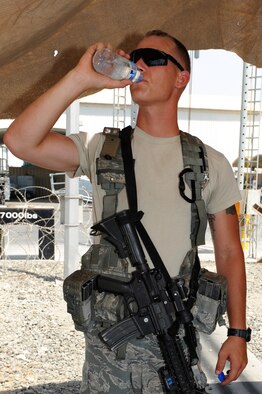 SOUTHWEST ASIA - U.S. Air Force Airman 1st Class Alexander Geary, 380th Expeditionary Security Forces Squadron patrolman, takes a break in the shade and Hydrates June 29, 2012. Geary is deployed from Tinker Air Force Base, Okla. (U.S. Air Force photo/Master Sgt. Scott MacKay)