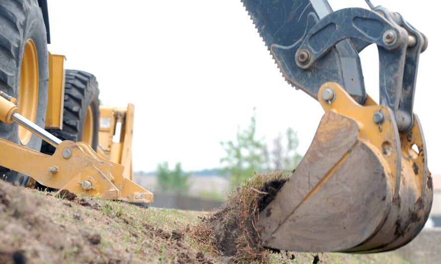 The 8th Civil Engineer Squadron clears dirt out of ditches June 28, 2012, Kunsan Air Base, Republic of Korea, to give the rain somewhere to go. Although a time-consuming process, clearing out the base’s 2.5 miles of drainage ditches potentially saves mission-critical assets. (U.S. Air Force photo/Senior Airman Brigitte N. Brantley)