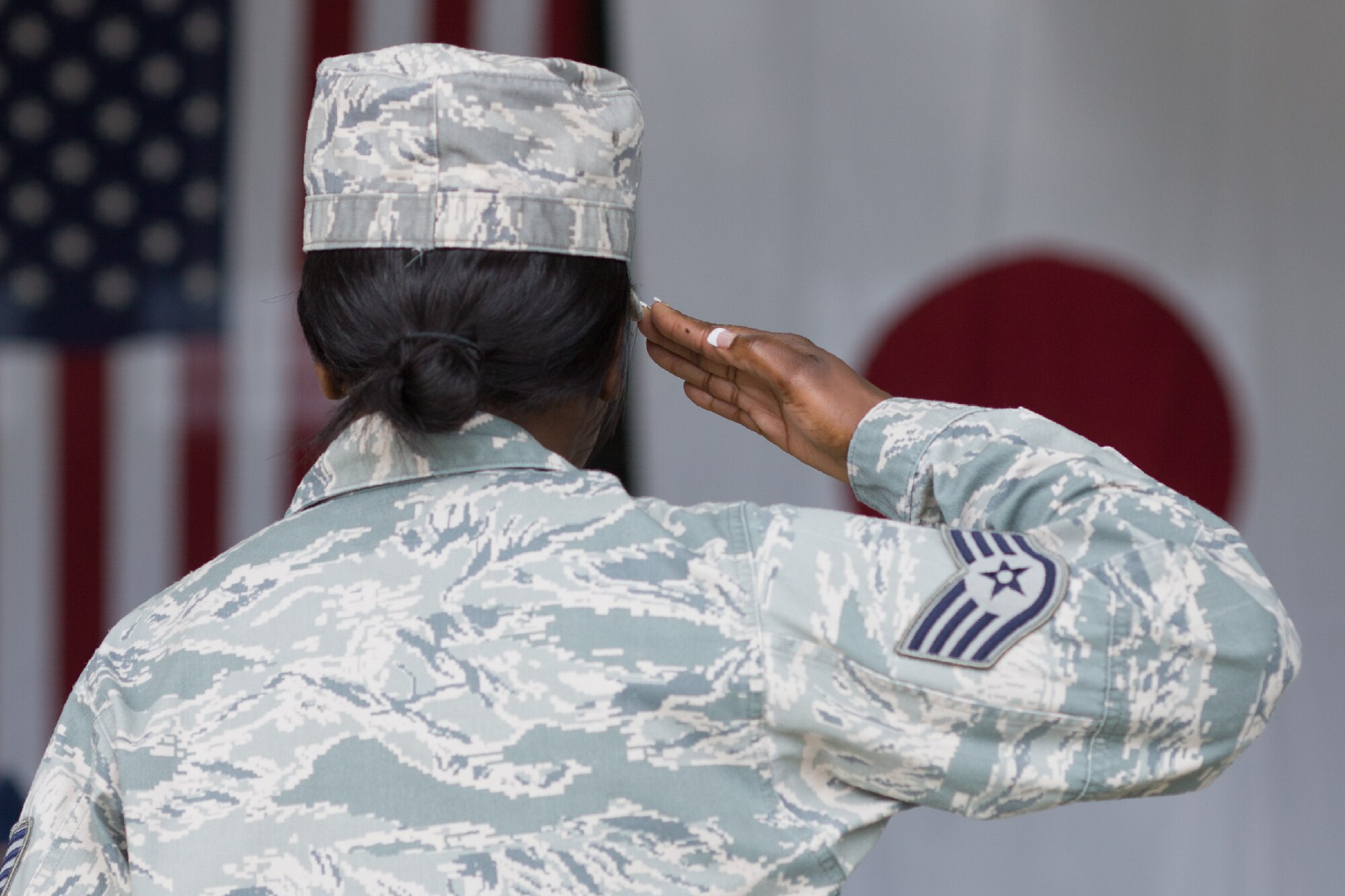 YOKOTA AIR BASE, Japan -- A staff sergeant salutes during the 374th Airlift Wing change of command ceremony at Yokota Air Base, Japan, on June 29, 2012. The change of command is a traditional military ceremony in which the departing commander assembles their personnel for presentation to the incoming commander. (U.S. Air Force photo by Osakabe Yasuo)
