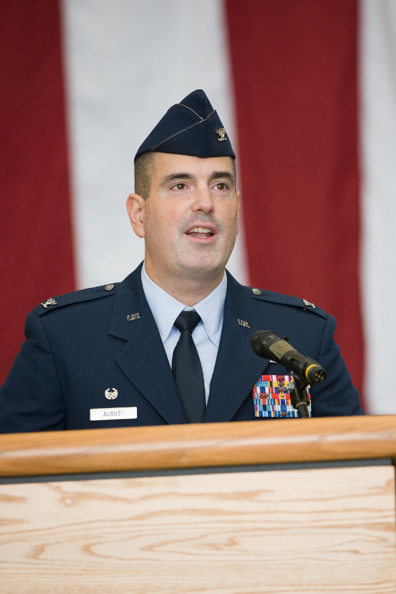 YOKOTA AIR BASE, Japan -- Col. Mark August, 374th Airlift Wing commander, speaks to Team Yokota members during a 374 AW change of command ceremony at Yokota Air Base, Japan, on June 29, 2012. August accepted command from Col. Bill Knight after serving as the commander of the 386th Expeditionary Operations Group in Southwest Asia. (U.S. Air Force photo by Osakabe Yasuo)