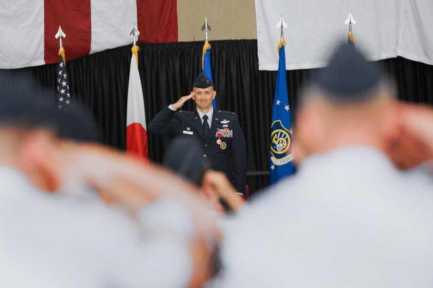 YOKOTA AIR BASE, Japan -- Col. Bill Knight, 374th Airlift Wing commander, returns a final salute as the commander of 374 AW during the change of command ceremony at Yokota Air Base, Japan, on June 29, 2012. Knight was responsible for the management, training, command and control of the Department of Defense's primary tactical airlift wing in the western Pacific region. (U.S. Air Force photo by Osakabe Yasuo)