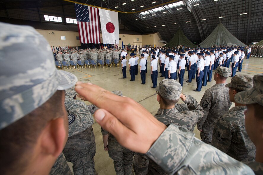 YOKOTA AIR BASE, Japan -- Yokota service members salute during the 374th Airlift Wing change of command ceremony at Yokota Air Base, Japan, on June 29, 2012. Members of Yokota, Japan Air Self-Defense Force and members of the local community attended the ceremony. (U.S. Air Force photo by Osakabe Yasuo)