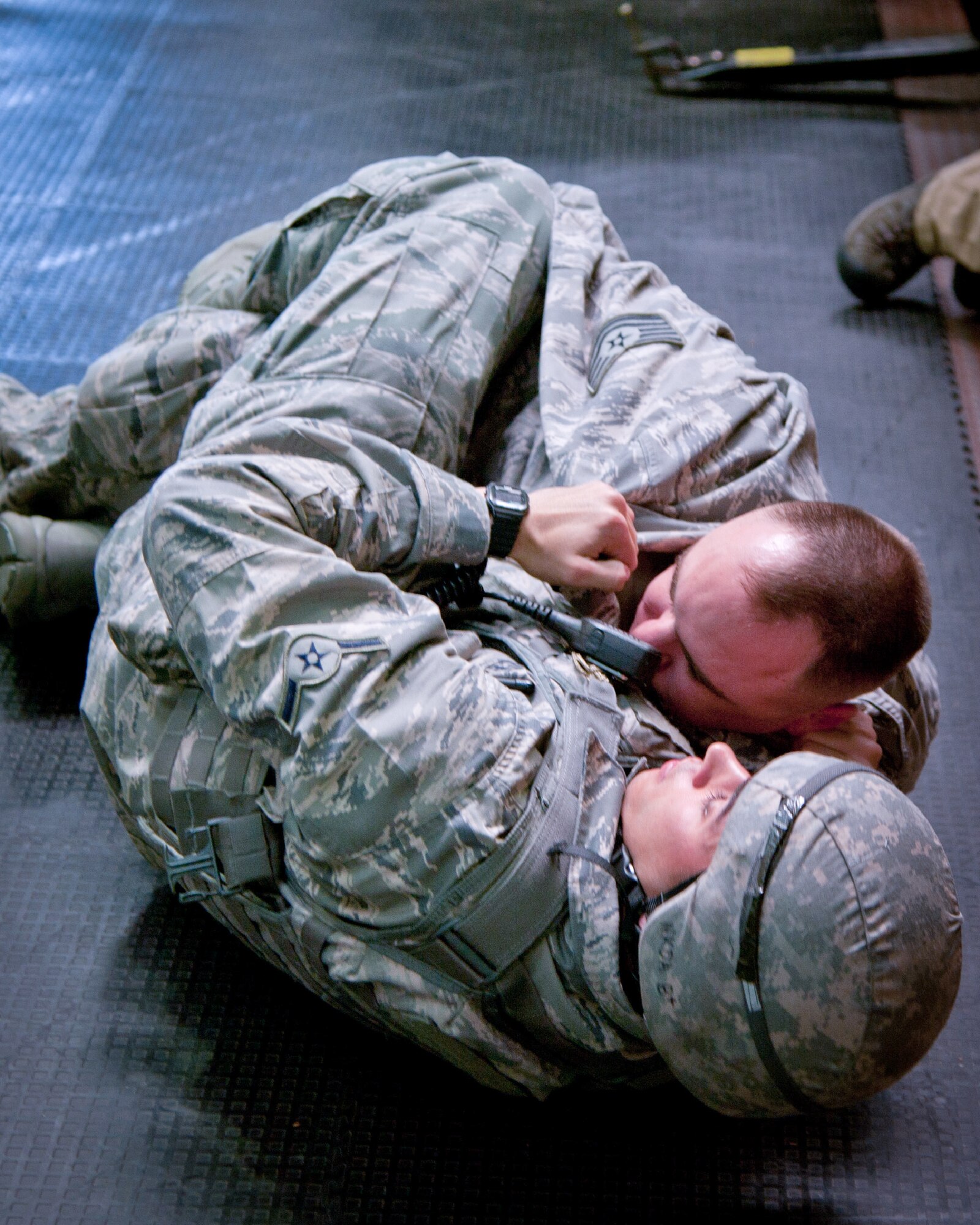 YOKOTA AIR BASE, Japan -- Airman 1st Class Enmanuel Crespo, left, 374th Security Forces Squadron patrolman, rolls a simulated suspicious person over so a fellow patrolman can search them during the First Responders Rodeo at Yokota Air Base, Japan, on June 26, 2012. Airmen trained on their capability to respond to a duress situation in the event that a threat arises. (U.S. Air Force photo by Osakabe Yasuo)
