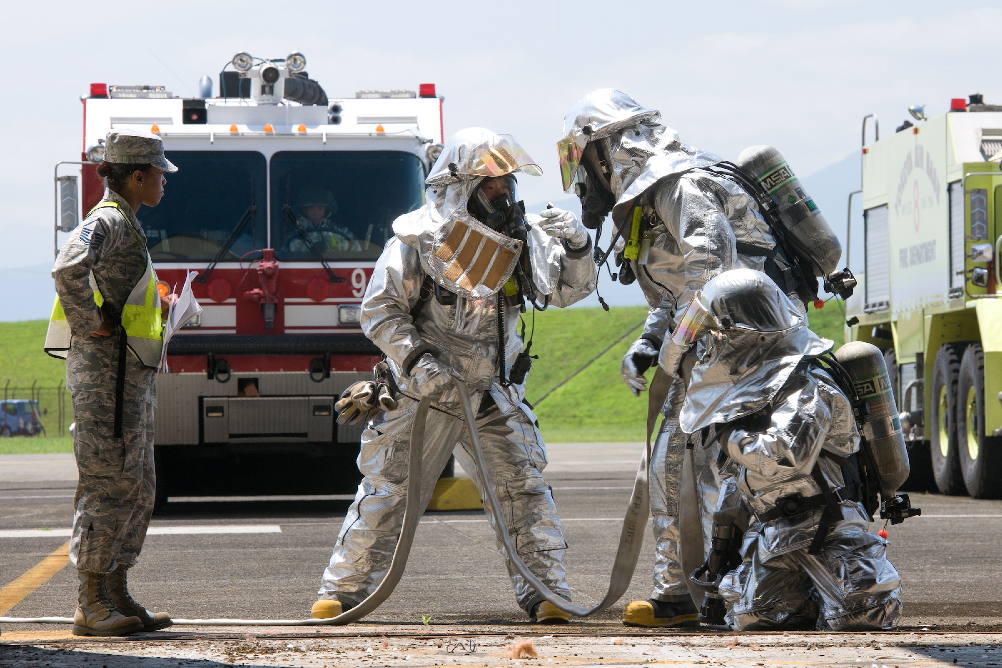 YOKOTA AIR BASE, Japan -- Master Sgt. Anisha Hall, left, 374th Airlift Wing plans and exercises wing inspector, evaluates firefighters during the First Responders Rodeo at Yokota Air Base, Japan, on June 26, 2012. The rodeo was an all day event that entailed emergency scenarios involving buildings and personnel around base and is meant to better train first responders assigned to various squadrons. (U.S. Air Force photo by Osakabe Yasuo) 