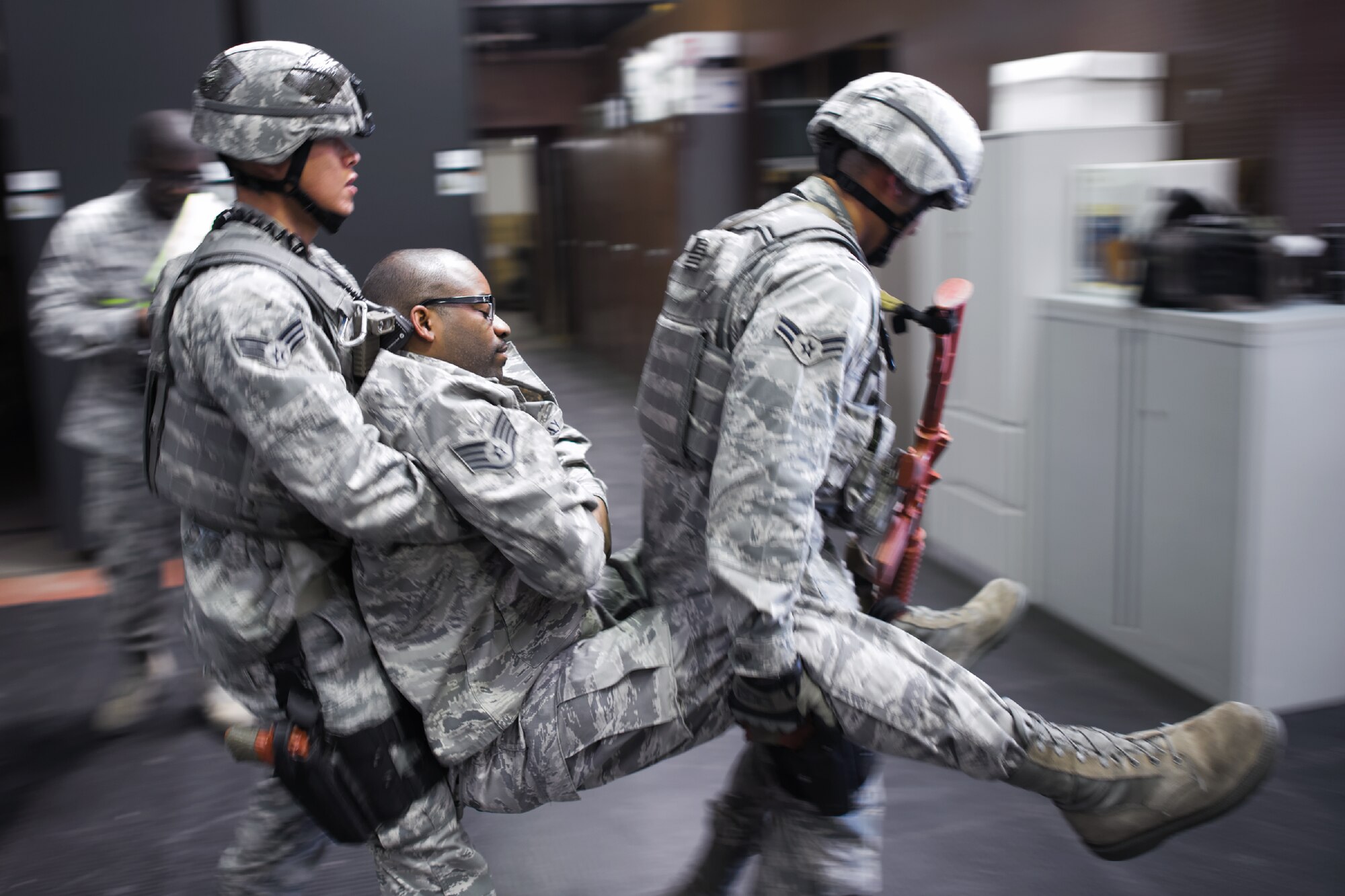 YOKOTA AIR BASE, Japan -- Patrolmen from the 374th Security Forces Squadron transport a simulated injured Airman during the First Responders Rodeo at Yokota Air Base, Japan, on June 26, 2012. The exercise enabled joint responders to coordinate proper response procedures in a simulated environment. (U.S. Air Force photo by Osakabe Yasuo)
