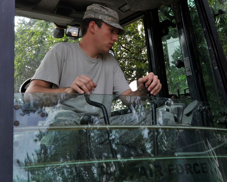 Senior Airman Joshua Cornwell, 8th Civil Engineer Squadron pavement and equipment journeyman, uses the backhoe to deepen the drainage ditches at Kunsan Air Base, Republic of Korea, June 29, 2012, in preparation for monsoon season. The dirt collected is reused to fill holes and maintain the dirt roads. (U.S. Air Force photo/Senior Airman Marcus Morris)
