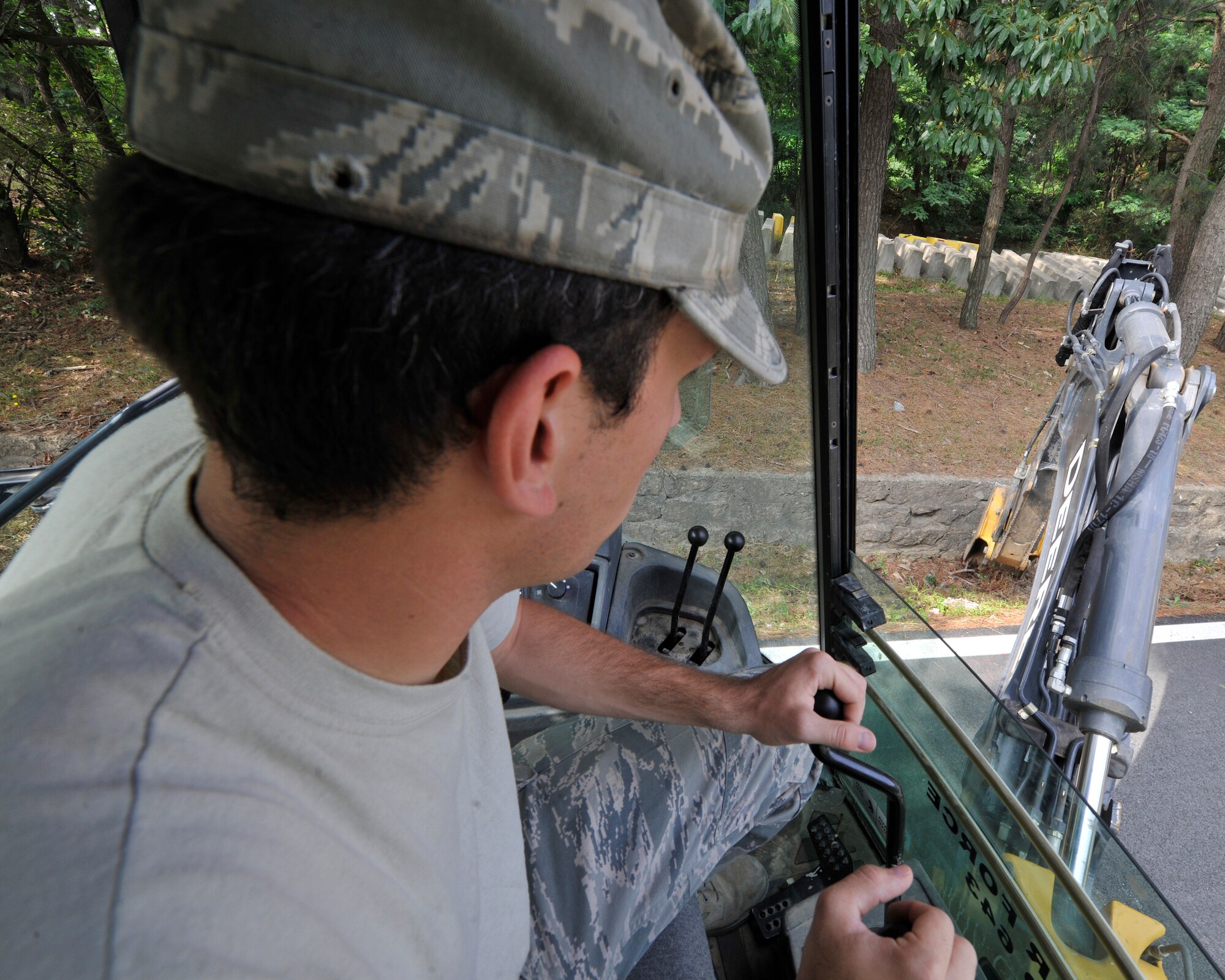 Senior Airman Joshua Cornwell, 8th Civil Engineer Squadron, pavement and equipment journeyman, digs out the drainage ditch in preparation of monsoons at Kunsan Air Base, Republic of Korea, June 29, 2012. Summer monsoon rainfall makes up 50 to 60 percent of the annual rainfall in South Korea. (U.S. Air Force photo/Senior Airman Marcus Morris)
