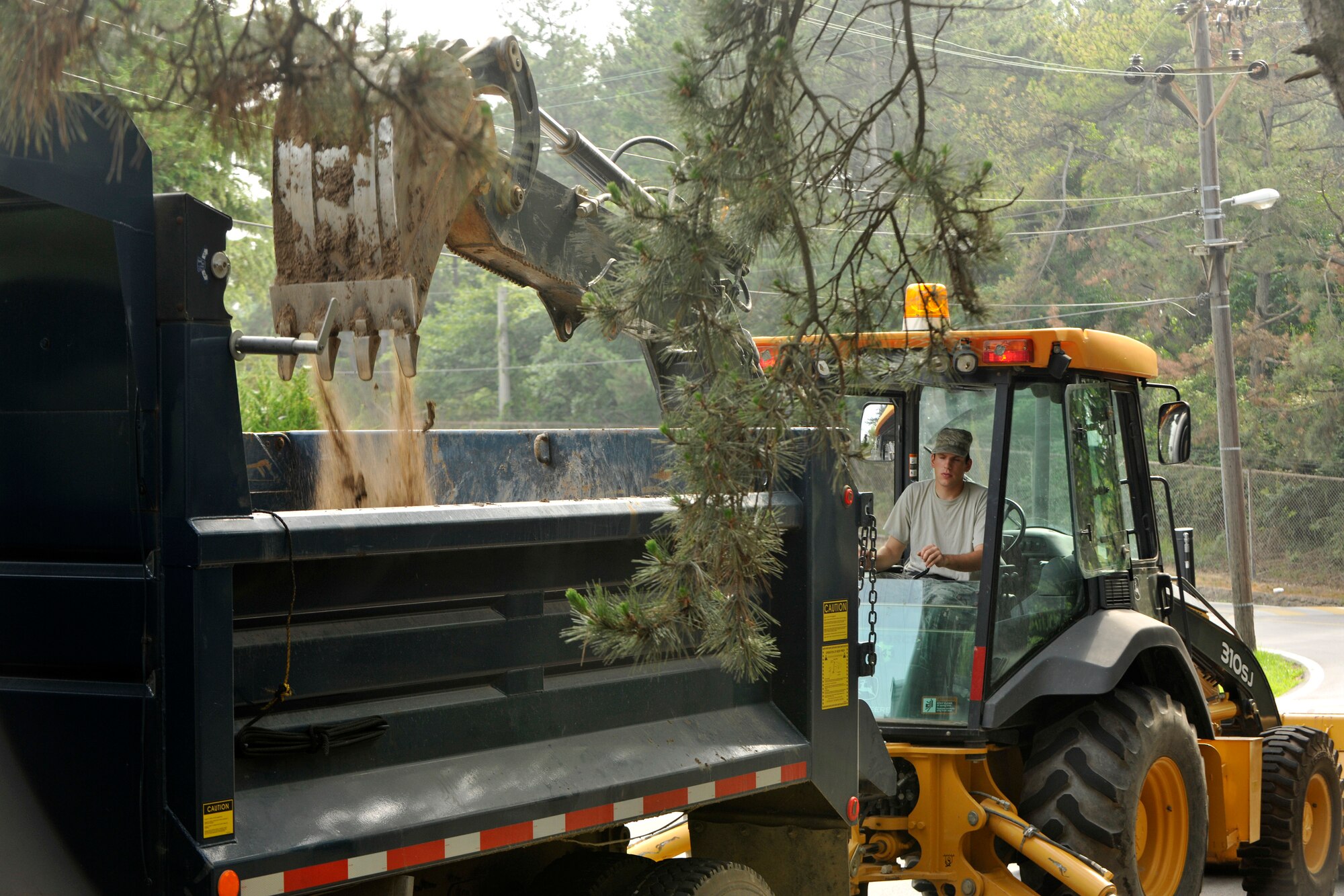 Senior Airman Joshua Cornwell, 8th Civil Engineer Squadron pavement and equipment journeyman, digs out the drainage ditch near Wolf Park at Kunsan Air Base, Republic of Korea, June 29, 2012. This is the first time in four years that the drainage ditches were dug out to prevent flooding from a monsoon. (U.S. Air Force photo/Senior Airman Marcus Morris)