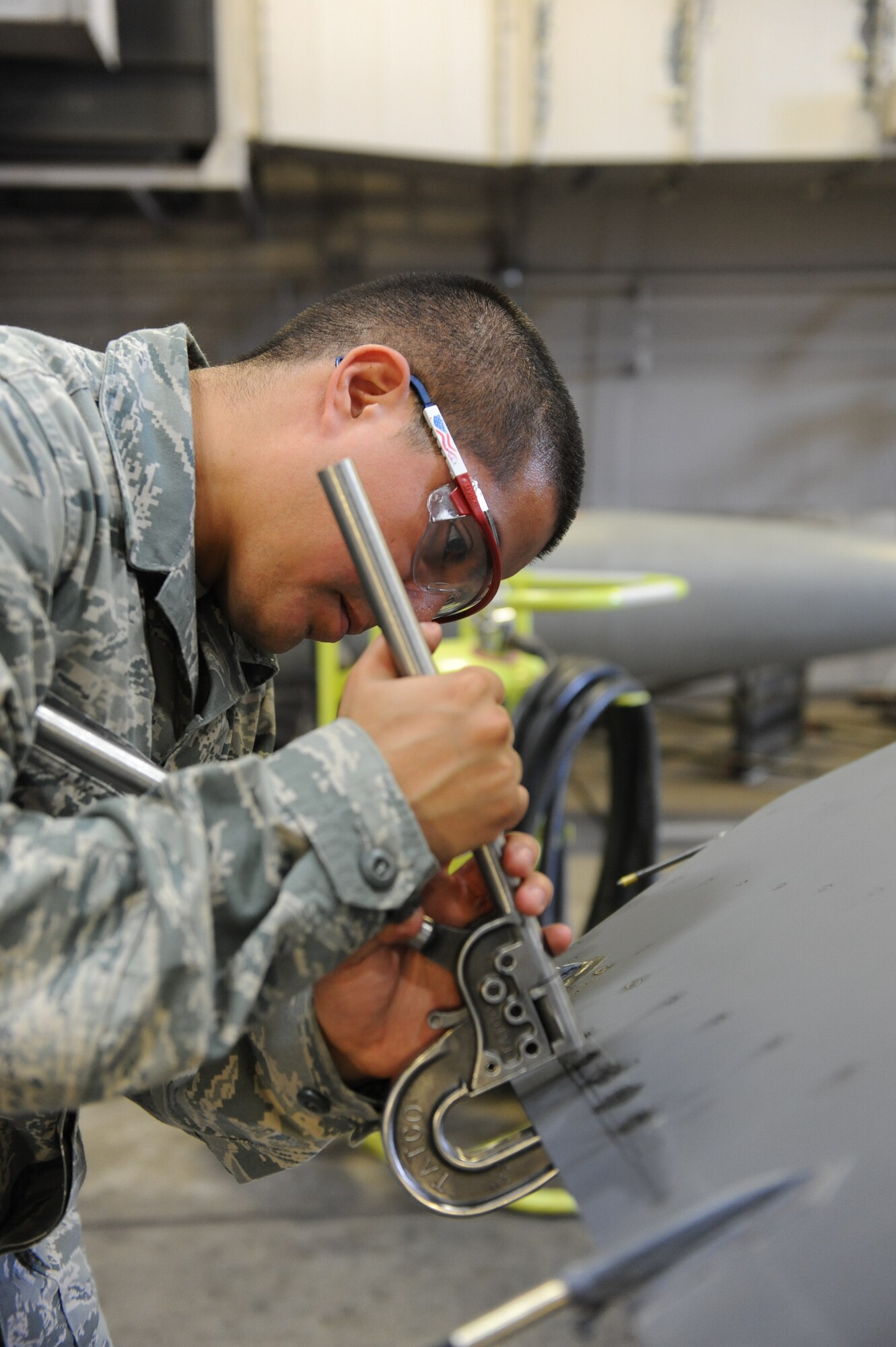 U.S. Air Force Staff Sgt. Jerry Rios, 35th Maintenance Squadron aircraft structural maintenance craftsman, installs trailing rivets on the horizontal edge of an F-16 Fighting Falcon at Misawa Air Base, Japan, June 28, 2012. Installation of the trailing edge rivets keeps components together and gives strength to the horizontal edge of the aircraft. (U.S. Air Force photo by Airman 1st Class Kia Atkins/Released)