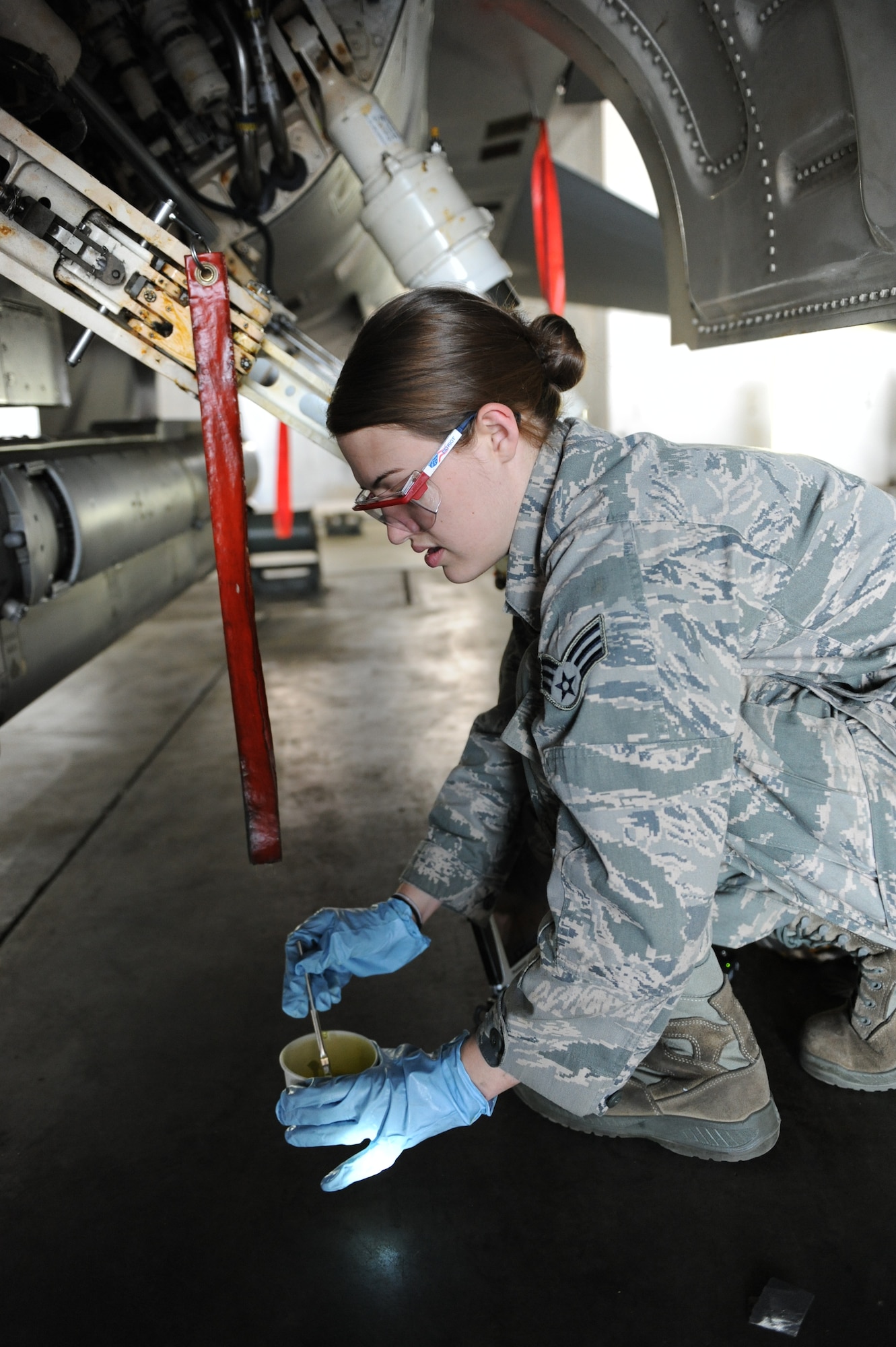 U.S. Air Force Senior Airman Brooke Williams, 35th Maintenance Squadron aircraft structural maintenance journeyman, prepares to put primer on an F-16 Fighting Falcon at Misawa Air Base, Japan, June 28, 2012. The primer protects the metal on the aircraft from erosion. When an aircraft is grounded due to physical damage, it is the job of aircraft structural maintenance Airmen to get it repaired and back in the air. (U.S. Air Force photo by Airman 1st Class Kia Atkins/Released)