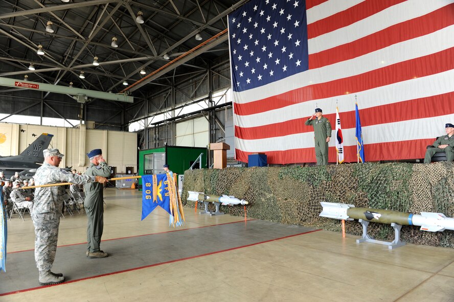 Col. James Sturgeon receives his first salute as 8th Operations Group commander after a change of command ceremony June 29, 2012, at Kunsan Air Base, Republic of Korea. As the OG commander, Sturgeon is responsible for missions which support armistice and wartime taskings to defend the Republic of Korea. (U.S. Air Force photo/Senior Airman Brigitte N. Brantley)