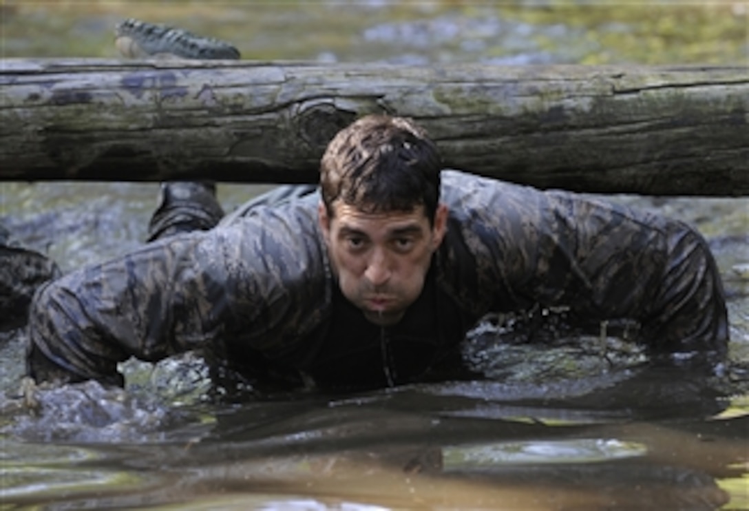 U.S. Air Force Maj. Christopher Wright navigates through a water obstacle during a combat mission readiness evaluation the Pre-Ranger Course at Fort Bragg, N.C., June 14, 2012.  Wright is the director of operations of the 14th Air Support Operations Squadron at Pope Field, N.C. 