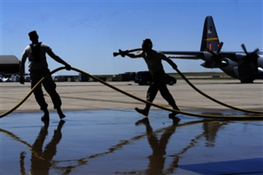 U.S. Air Force airmen with the 302nd Airlift Wing prepare to stow a fire hose after filling a Modular Airborne Firefighting System (MAFFS) II aboard a C-130 Hercules aircraft at Peterson Air Force Base, Colo., on June 27, 2012.  Four MAFFS-equipped aircraft flew missions to help fight the Waldo Canyon fire in Colorado Springs, a blaze that started four days earlier and burned several hundred homes, forcing large-scale evacuations in Colorado Springs and at the Air Force Academy. MAFFS II is a self-contained aerial firefighting system that can discharge 3,000 gallons of water or fire retardant in less than five seconds.  