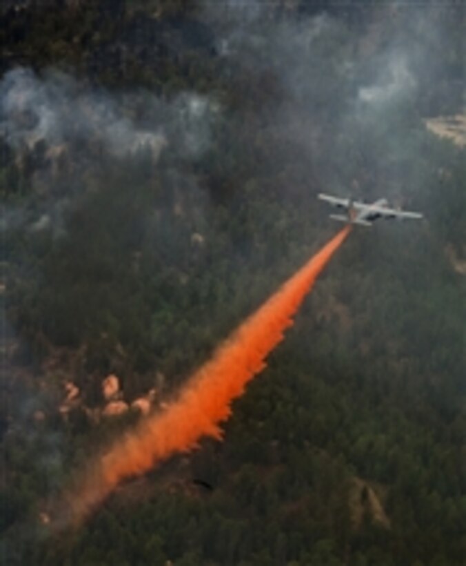 A U.S. Air Force C-130 Hercules aircraft uses a modular airborne firefighting system (MAFFS) to spread fire retardant to fight the Waldo Canyon wildfire in Colorado Springs, Colo., on June 28, 2012.  Four MAFFS-equipped aircraft with the 302nd and 153rd Airlift Wings are flying in support of the U.S. Forest Service.  The Waldo Canyon fire, which started June 23, 2012, has burned several hundred homes and forced large-scale evacuations in Colorado Springs and at the U.S. Air Force Academy. 
