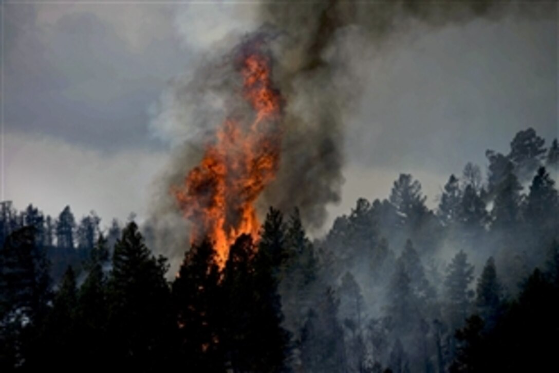 Fire continues to burn in Waldo Canyon, Colo., while firefighters cut fire lines in the Peregrine neighborhood of Colorado Springs, June 28, 2012. The Waldo Canyon fire has claimed 18,500 acres and burned more than 300 homes. The U.S. Air Force Academy, U.S. Air Force Space Command, Warren Air Force Base, Wyo., and Fort Carson, Colo., have joined local organizations to fight the fires.