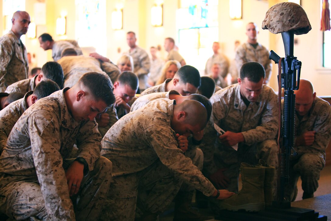 Marines with 1st Law Enforcement Battalion, I Marine Expeditionary Force, take a moment to pay tribute to fallen Marine Cpl. Keaton G. Coffey during a memorial service at the Marine Memorial Chapel at Camp Pendleton, Calif., June 28. The 22-year-old Marine, from Boring, Ore., was killed in action, May 24, during combat operations in Helmand province, Afghanistan. Coffey was serving his second tour as a military police dog handler with 1st LE Bn.