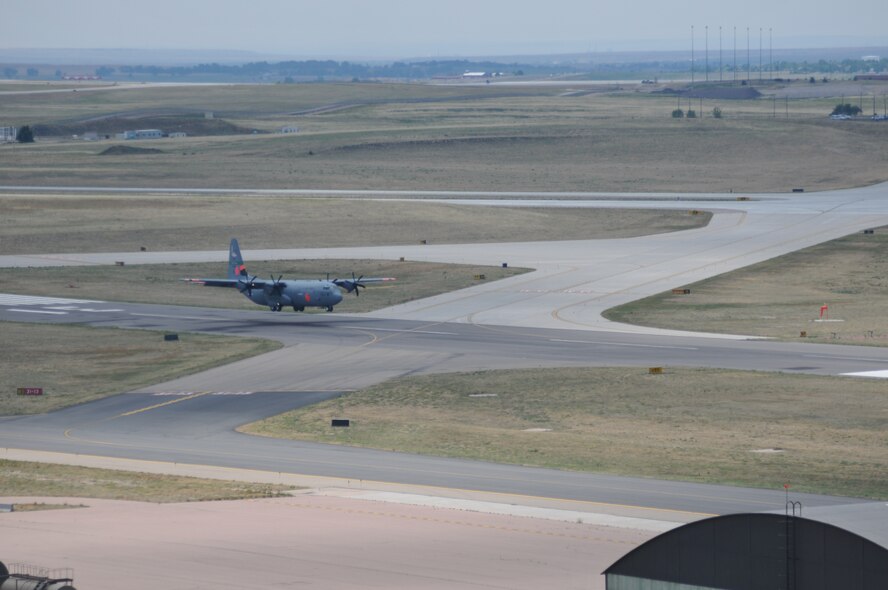 A Modular Airborne Fire Fighting Sytem equipped-C-130 assigned to the Cailfornia Air National Guard's 146th Airlift Wing arrives June 30 at Peterson Air Force Base, Colo. The 146th AW joins the 153rd Air Expeditonary Group tasked with providing requested MAFFS assistance through out the Rocky Mountain area. (U.S. Air Force photo/Airman 1st Class Nichole Grady)