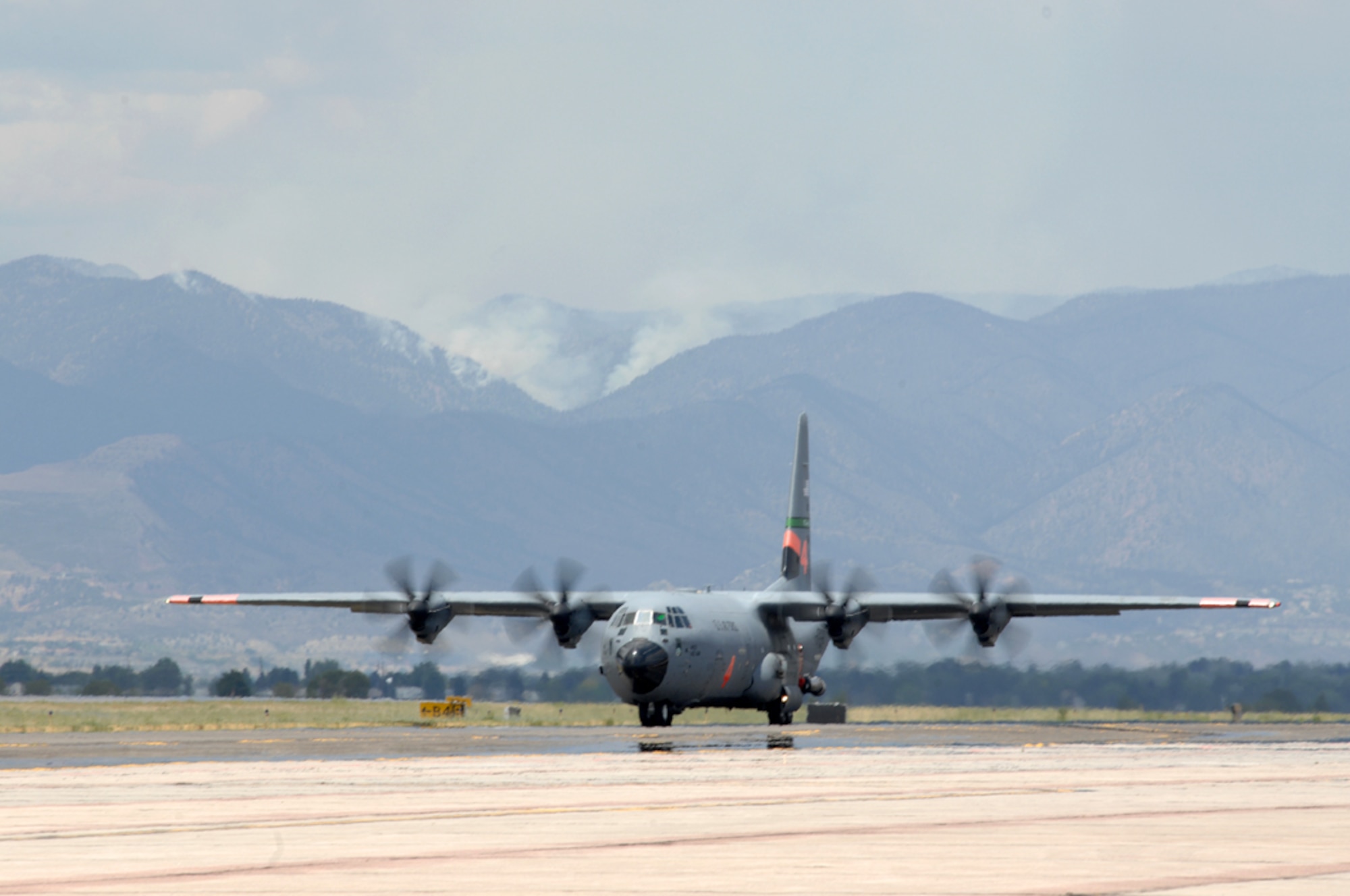 A Modular Airborne Fire Fighting System-equipped C-130 from the California Air National Guard's 146th Airlift Wing arrives June 30 at Peterson Air Force Base, Colo., to support wildland fire fighting operations in the western United States. Four MAFFS units are scheduled to arrive June 30, joining four already operating from this southern Colorado air force base. The eight MAFFS units constitute the entire U.S. military's MAFFS fleet. (U.S. Air Force photo/Tech. Sgt. Thomas J. Doscher)