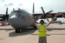 Airman Raymond DeSoto marshals a Modular Airborne Fire Fighting System-equipped C-130 June 29 on the Peterson Air Force Base taxiway in Colorado. MAFFS aircraft from both the 302nd and 153rd Airlift Wings have been supporting Colorado wildland fire fighting efforts since June 25. DeSoto is assigned to the 302nd Aircraft Maintenance Squadron, a subordinate organization to the 302nd AW. (U.S. Air Force photo/Tech. Sgt. Thomas J. Doscher)