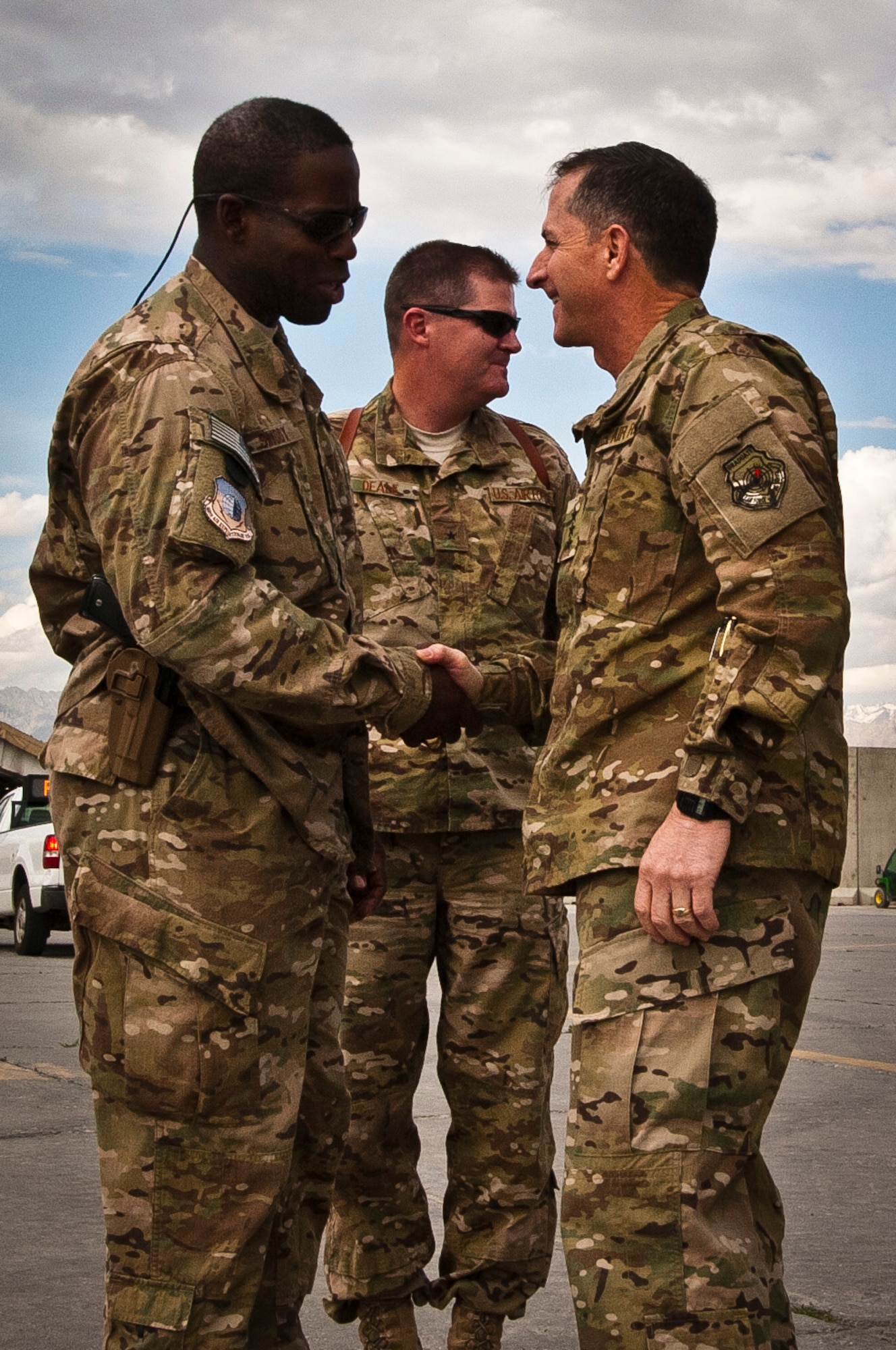 CMSgt Marcus Snoddy, 455th Air Expeditionary Wing command chief master sergeant, greets Lt. Gen. David Goldfein, Air Force Central Command commander June 28, 2012, as he arrives at Bagram Airfield, Afghanistan, as Brig. Gen. Thomas Deale, 455th Air Expeditionary Wing commander, looks on. (U.S. Air Force photo/Capt. Raymond Geoffroy)