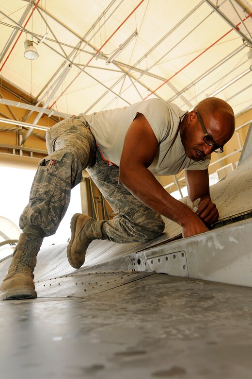 Airman 1st Class Reginald Brown, a phase dock crew chief with the 451st Expeditionary Aircraft Maintenance Squadron at Kandahar Airfield, Afghanistan, works on components inside an F-16 while the plane is undergoing a phase inspection on June 26, 2012. A phase inspection, done in the phase dock, is completed every 400 hours of flying time and is a detailed inspection of the aircraft. Members of the 169th Fighter Wing at McEntire Joint National Guard Base, S.C., are deployed to KAF in support of Operation Enduring Freedom. Swamp Fox F-16s, pilots, and support personnel began their Air Expeditionary Force deployment early April to take over flying missions for the air tasking order and provide close air support for troops on the ground in Afghanistan. (U.S. Air Force photo/Tech Sgt. Stephen Hudson)