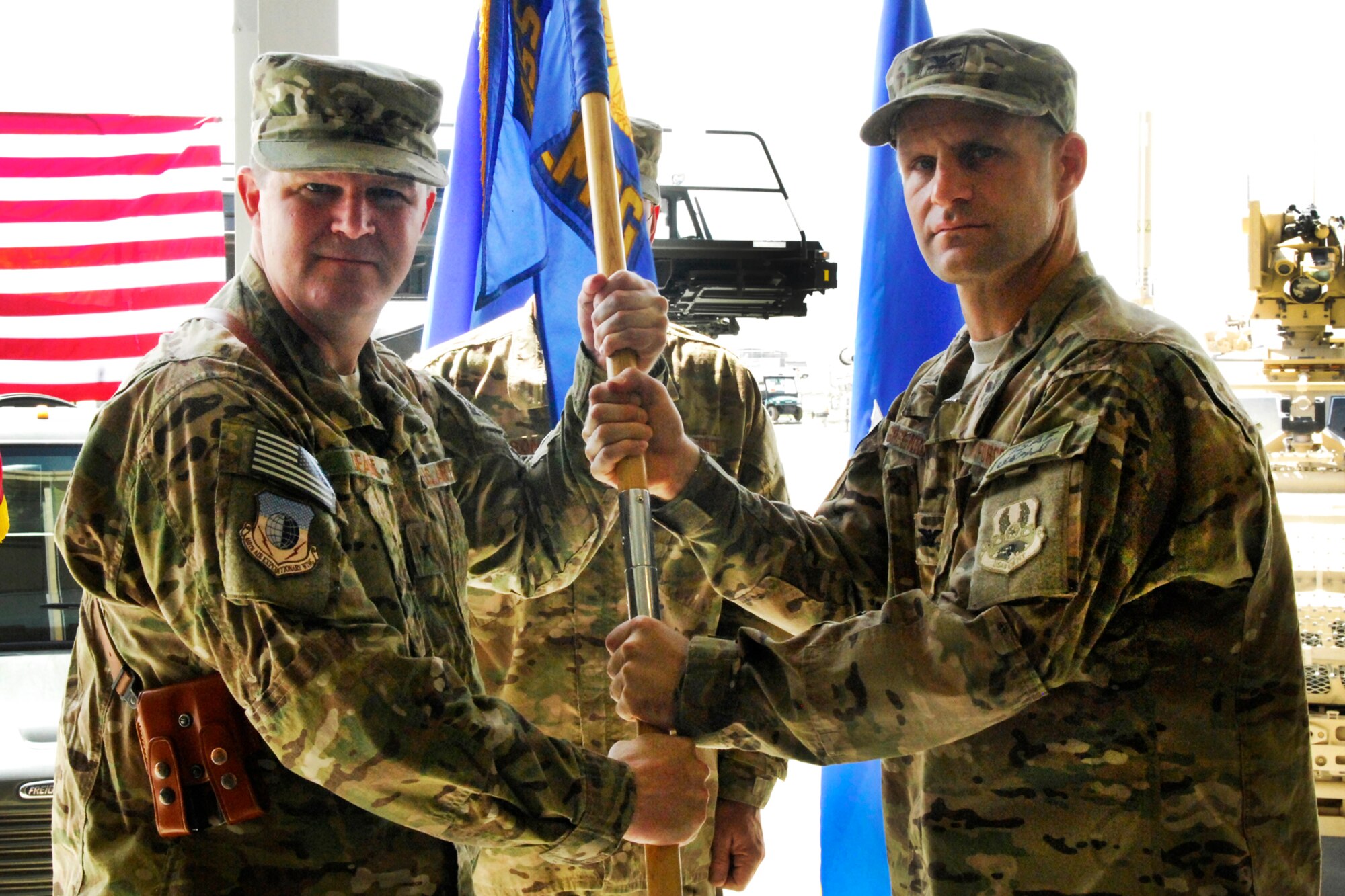 Col. Brian Greenroad (right), assumes command of the 455th Expeditionary Mission Support Group as he is he receives the group guidon from Brig. Gen. Thomas Deale, 455th Air Expeditionary Wing commander at Bagram Airfield, Afghanistan, June 28, 2012. (U.S. Air Force photo/Staff Sgt. Jeff Nevison)