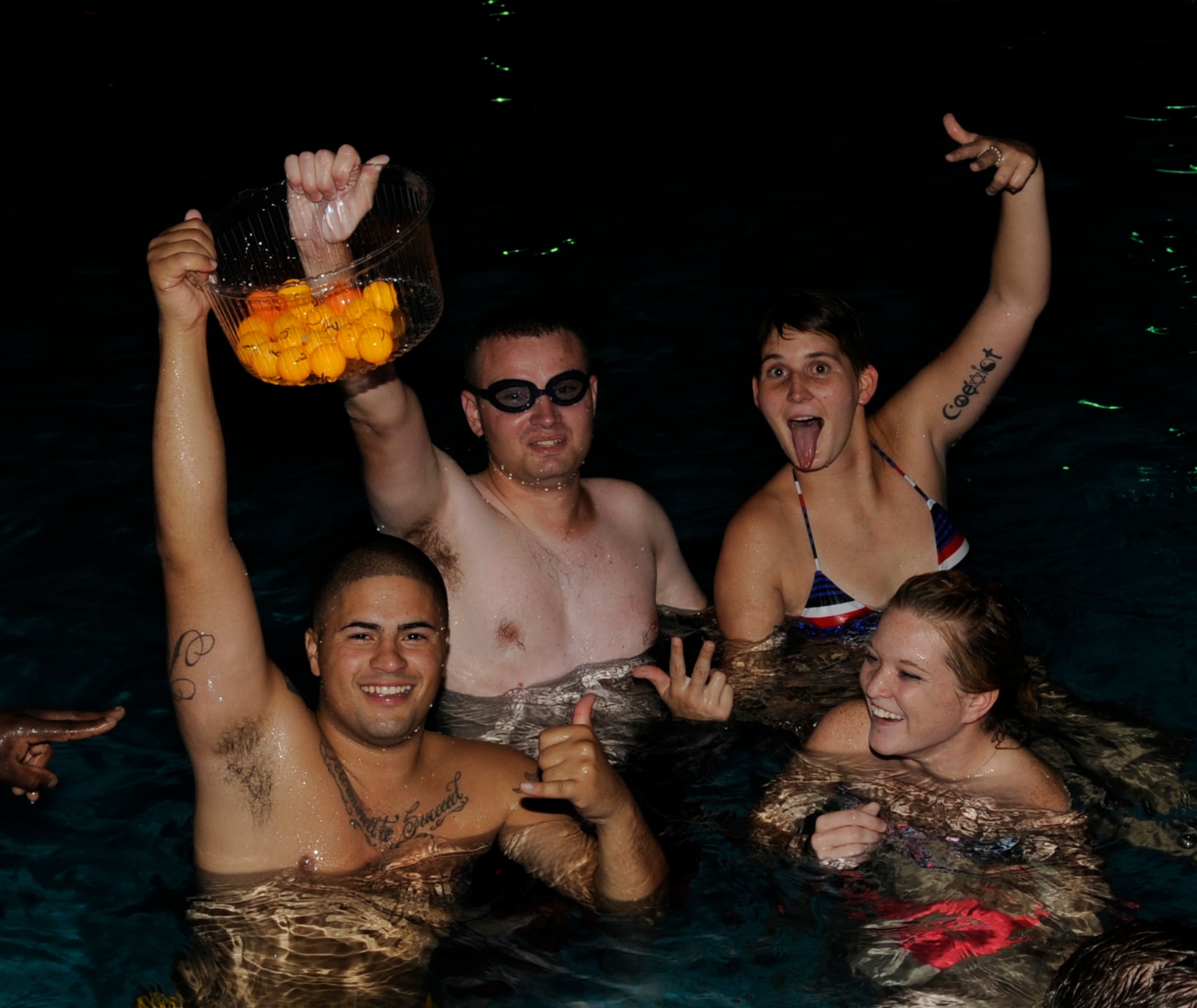 SOUTHWEST ASIA – Members of the 386th Air Expeditionary Wing display their ping-pong balls during the 101 Days of Summer Pool Party hosted by the 386th Expeditionary Force Support Squadron here June 23. The objective was the collect as many ping-pong balls and tally up the number that was on them.  (U.S. Air Force photo/Staff Sgt. Alexandra M. Boutte) 