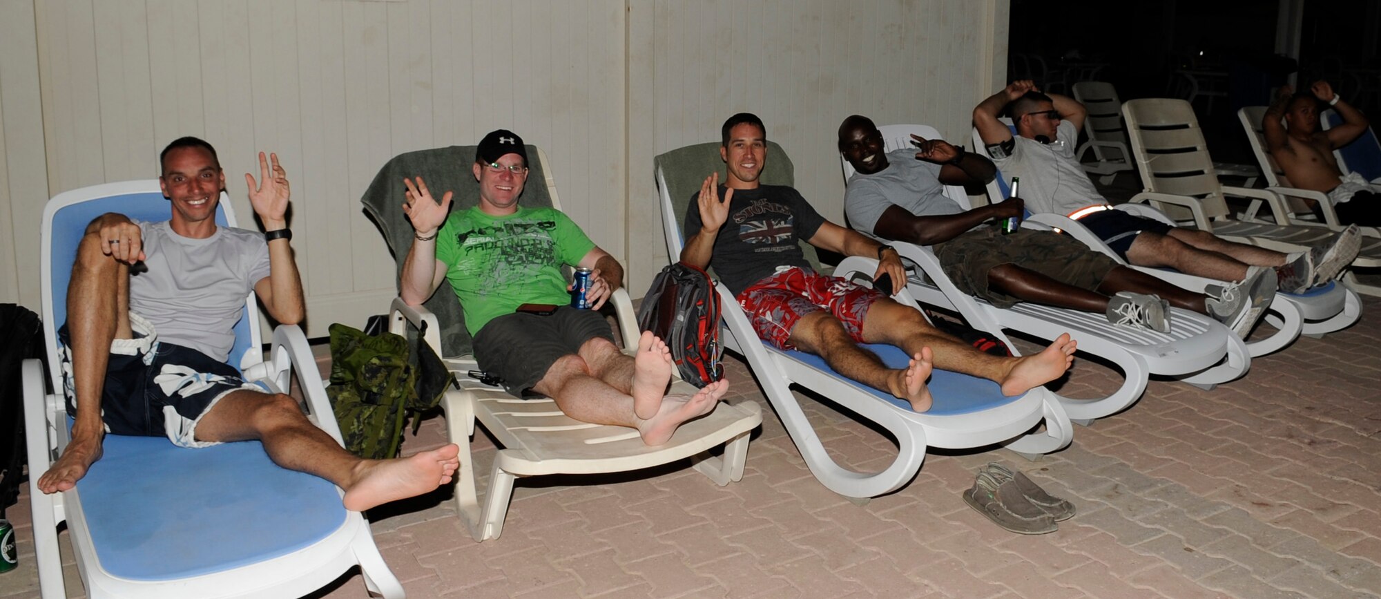 SOUTHWEST ASIA – Spectators enjoy the 101 Days of Summer Pool party races hosted by the 386th Expeditionary Force Support Squadron here June 23. Airmen participated in a rubber ducky race, noodle race and ping-pong pick-up. (U.S. Air Force photo/Staff Sgt. Alexandra M. Boutte) 