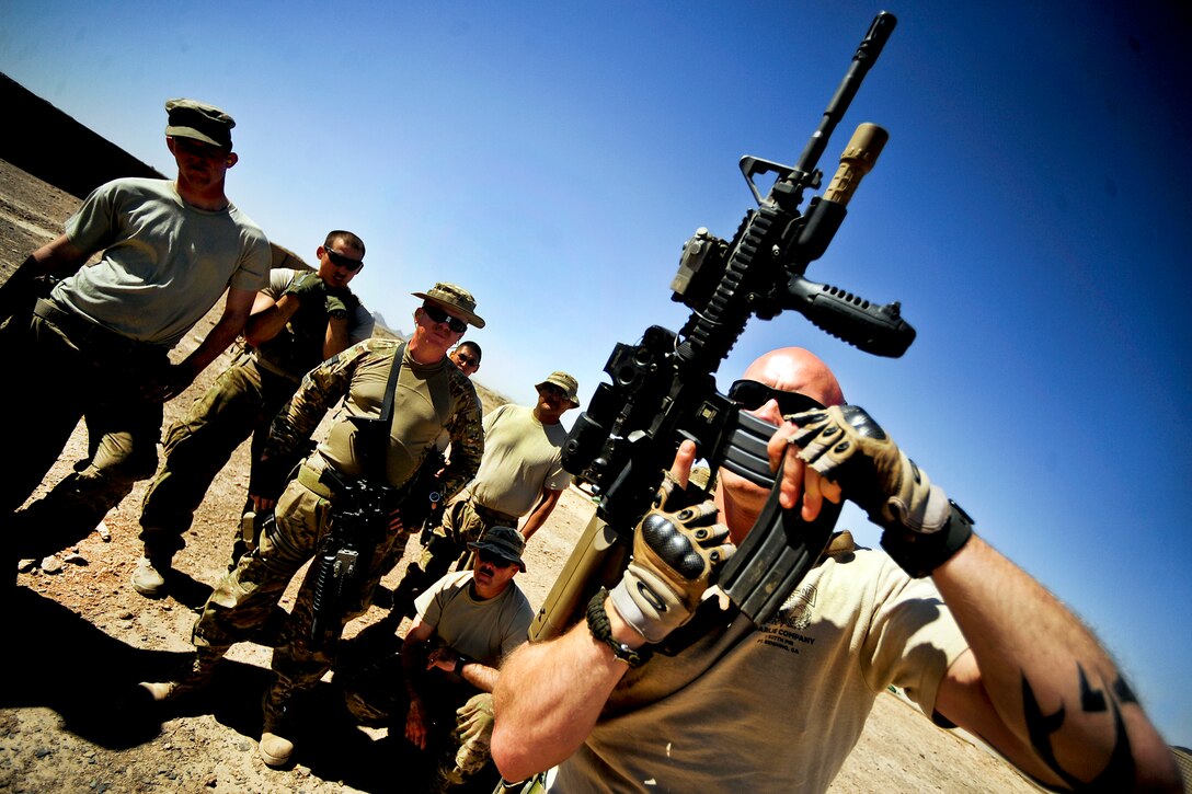 U.S. Army Staff Sgt. James Bates demonstrates a combat reload with his M4 assault rifle during a small-arms training session on Forward Operating Base Farah in Afghanistan's Farah province, June 26. During the training, soldiers learned proper techniques for performing reloads and close quarters shooting. Bates is a security force squad leader for the team.