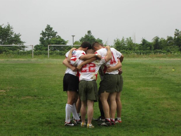 The rugby team consisting of Marine Corps Air Station Iwakuni Marines huddle together before the second half of a game held at Hiroshima City University June 30, 2012. The team played and won a total of three games. They beat the Hiroshima Kyion Rugby Club 20-10. In the next game they beat the Hiroshima City University rugby team 25-5. In the final game they won 20-15, against a team consisting of both Hiroshima Kyion Rugby club and Hiroshima City University rugby team players.