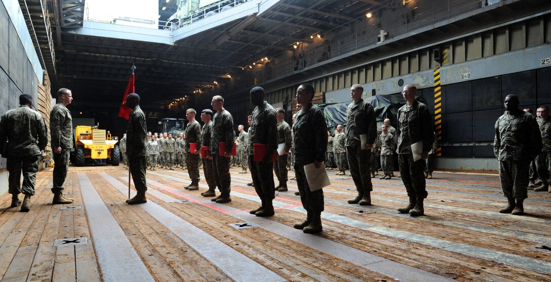 Two newly promoted corporals and other awardees of Combat Logistics Battalion 31, 31st Marine Expeditionary Unit, stand at attention before Lt. Col. William Arick, commanding officer of CLB-31, 31st MEU, during a promotion ceremony aboard the forward-deployed amphibious dock landing ship USS Germantown (LSD 42).  Elements of the 31st MEU embarked on Germantown to participate in Cobra Gold 2012, an annual Thai-U.S. co-sponsored joint and multinational exercise designed to advance security throughout the Asia-Pacific region and enhance interoperability with participating nations. (U.S. Navy photo by Mass Communication Specialist 1st Class Johnie Hickmon/Released)