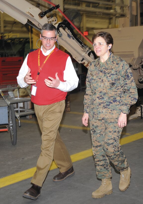 Rear Adm. Margaret Kibben, tours the former Maintenance Center Albany, Feb. 22. She listened as Trent Blalock, deputy commander, Production Plant Albany, Ga., MDMC, explained the maintenance processes there.