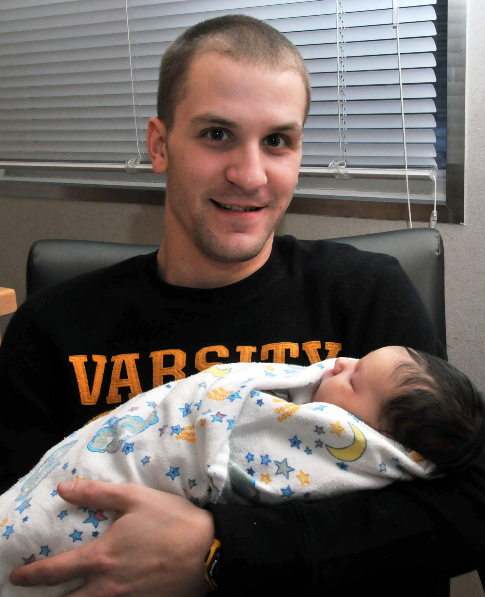 Staff Sgt. Ben Rea, 374th Maintenance Squadron repair and reclamation craftsmen, holds his daughter Aubreigh Essie March 1, 2012 in the hospital at Yokota Air Base, Japan. Aubreigh, born at 11:36 p.m. on Feb. 29, 2012, was one of two babies born on Leap Day at Yokota.  (U.S. Air Force photo/Airman 1st Class Desiree Economides)