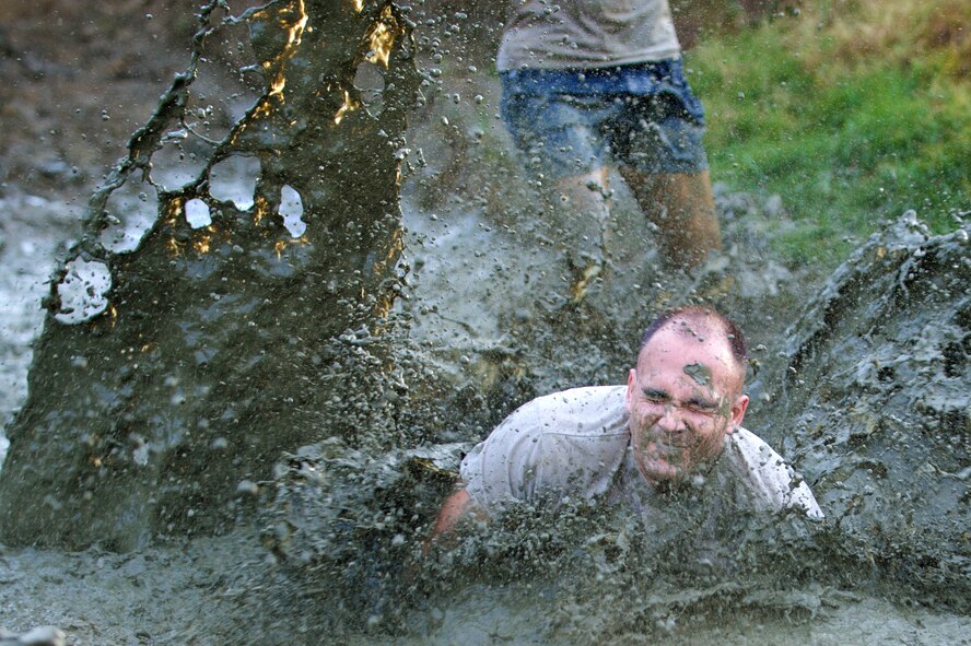 There were no allies during certain sections of the Swamp Romp, even among team members, as competitors take on a five-mile run through the mud along the Nu'upia ponds and down the Fort Hase Beach at Marine Corps Base Hawaii - Kaneohe Bay, Feb. 25, 2012. This unique run, known as the "Dirtiest race in Hawaii" takes teams  over and under the challenge-laden course that included unlimited mud, low crawling, jumping, climbing and falling in the mud. (U.S. Air Force photo/Staff Sgt. Mike Meares)